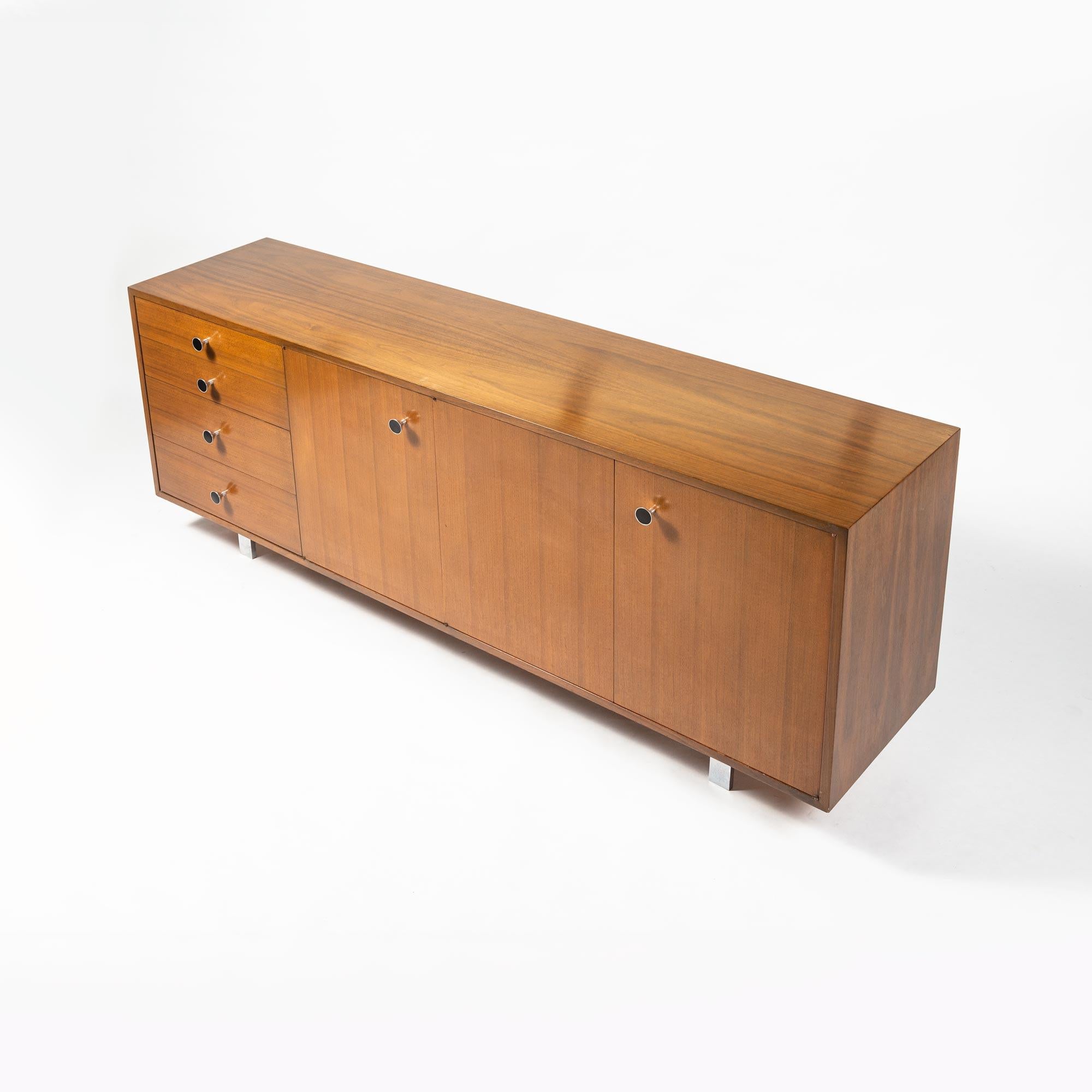 This George Nelson special-order cabinet from Herman Miller that has several custom features including a cork-lined pull-out for glassware, slits for cookie sheet storage, a pull-out butcher's block cutting board, and double drawers, all in great
