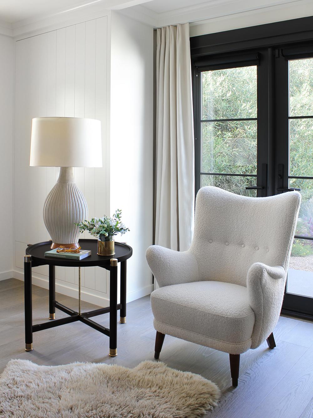 The Otto side table is a generously proportioned table with a simple, well, articulated form.
Available in ebonized oak, it features a round coupe top, substantial antique brass fittings, a central brass stem, and sleek chamfered stretchers. The