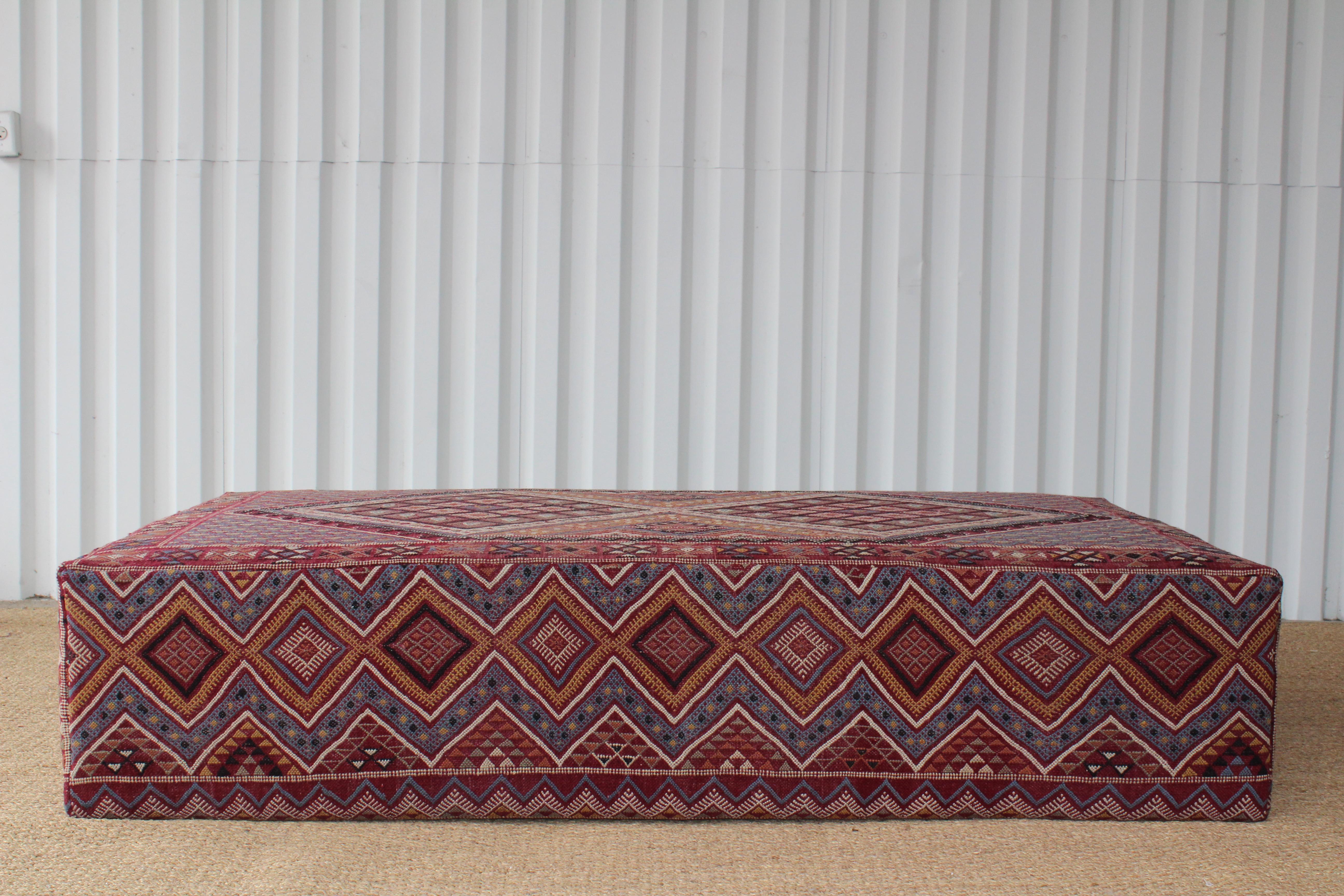 Large, custom made ottoman, upholstered with a vintage Turkish rug from the 1960s. Wonderful condition, rug has been professionally cleaned and has no stains, rips, or tears.