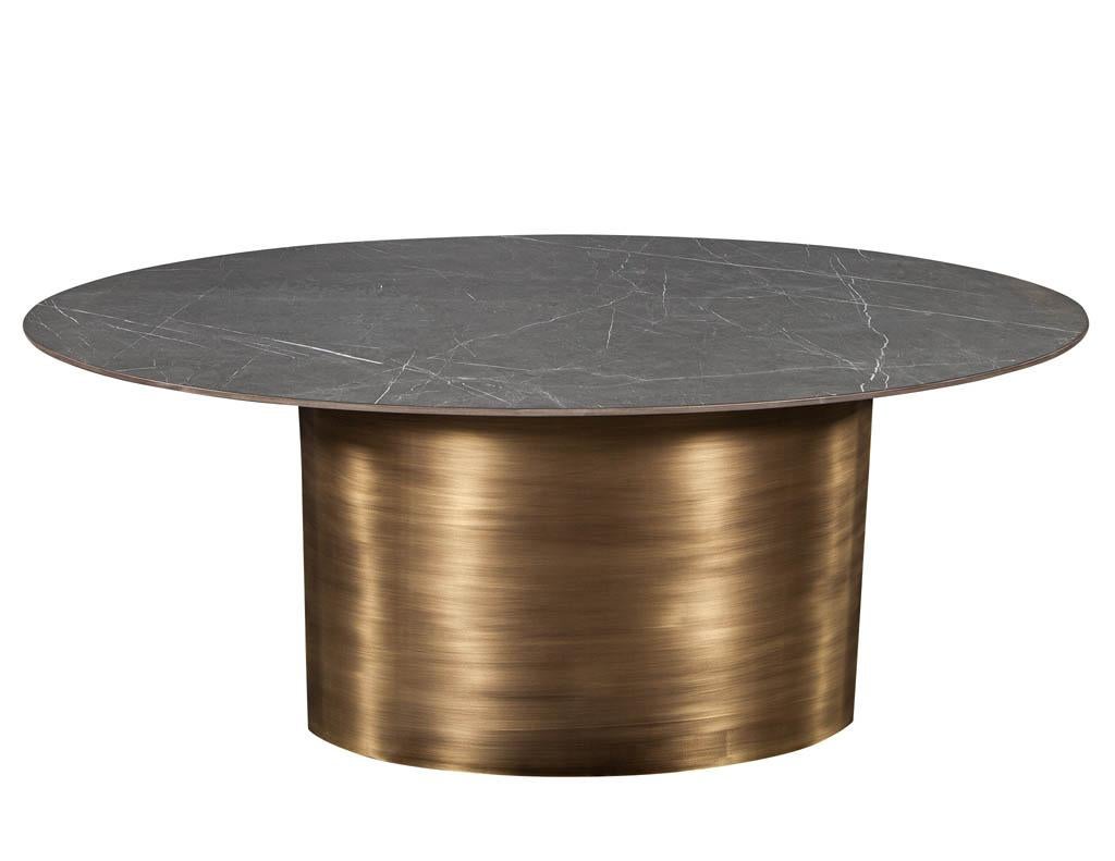 Custom oval porcelain top dining table with brass demi lune base by Carrocel. This table perches atop two antique brass demi lune bases and has an oval porcelain top. Please note this table is custom ordered with a 12 week lead time.

Price