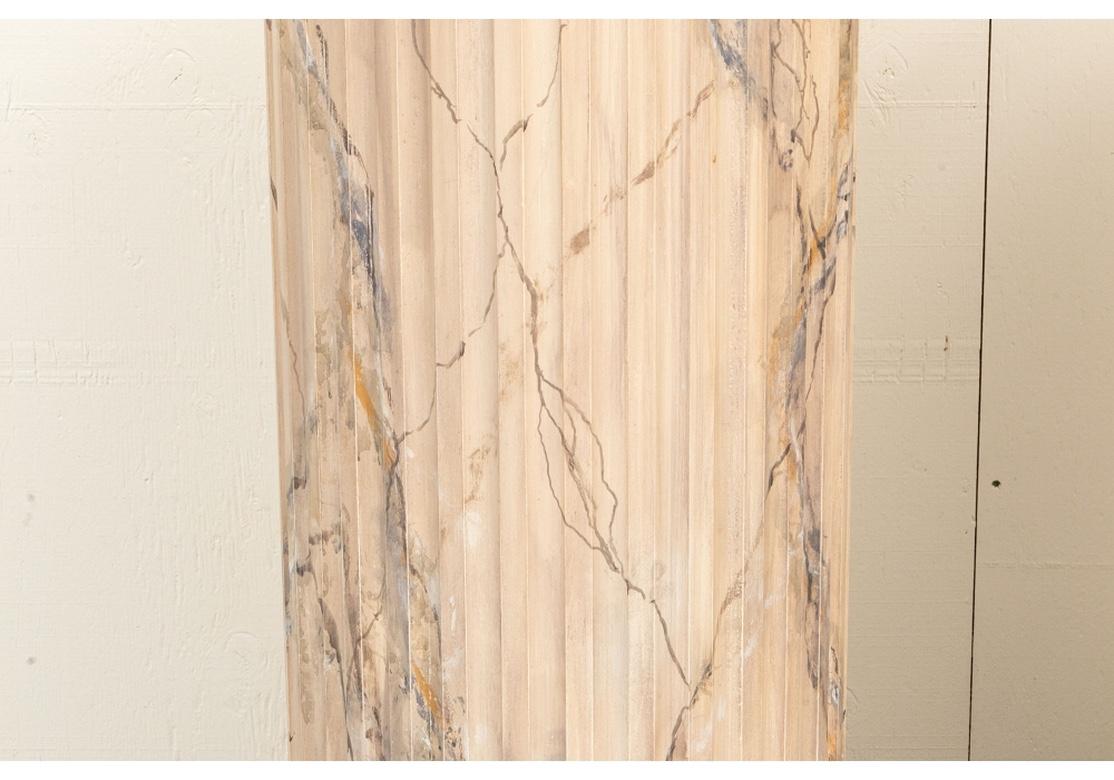 A pair of custom made Classic column form pedestals. The columns in gray and cream with some brown painted areas, mounted on gray faux marble bases. With very good size and proportions, as architectural as they are decorative.
Measures: Total