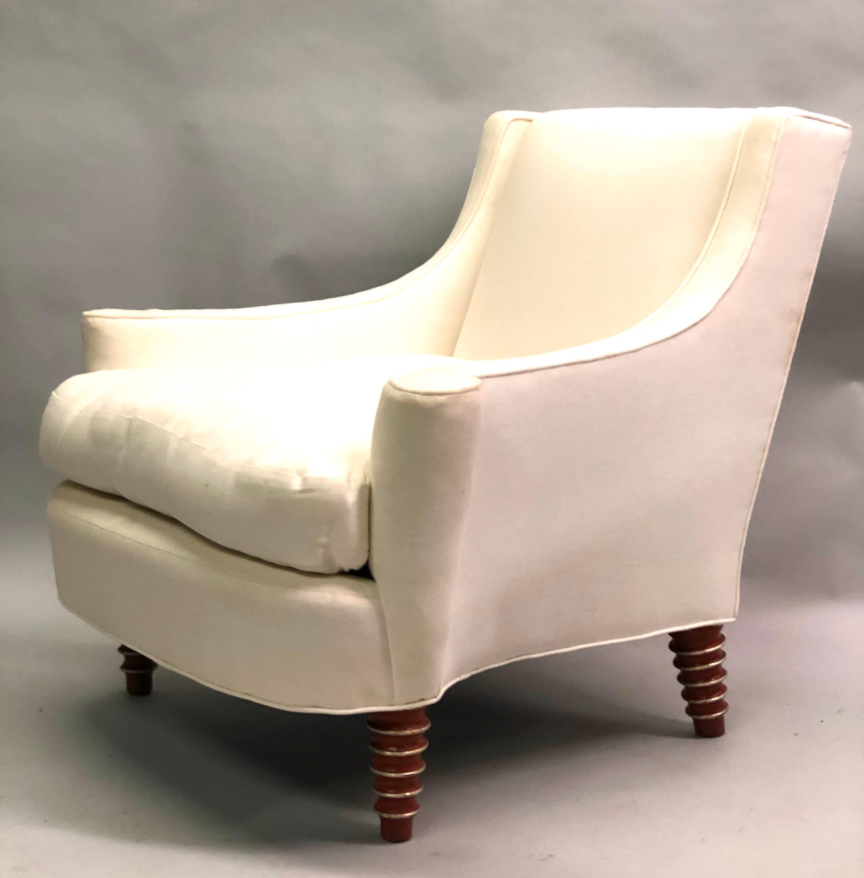 Custom pair of French modern neoclassical lounge chairs or armchairs designed by New York decorator Howard Elliot and manufactured by Maison Jansen. The chairs utilize a classic Maison Jansen form: the legs are hand carved and tapered utilizing a