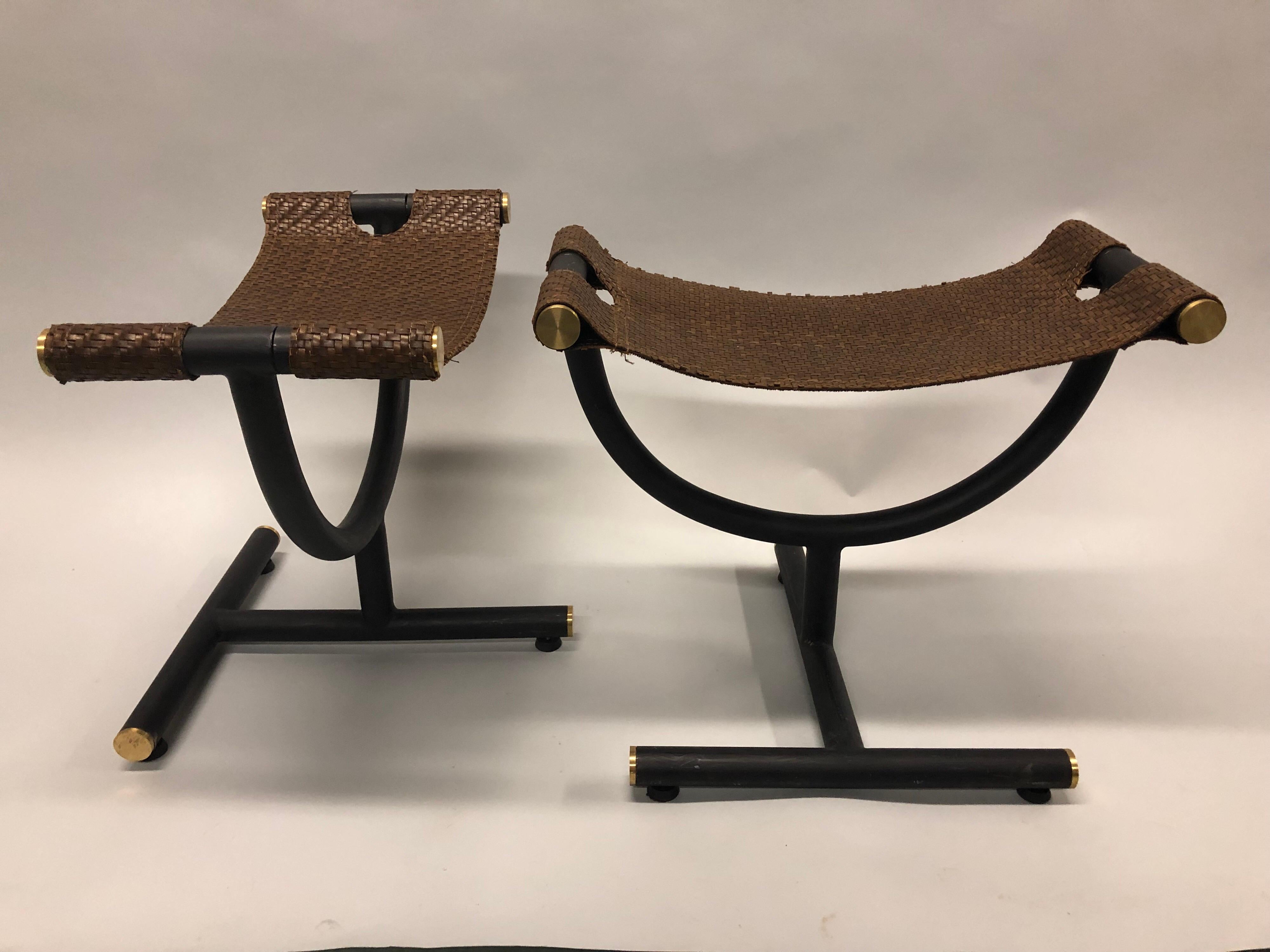 Elegant, custom pair of Italian late 20th century iron and braided leather benches / stools for Gucci
The braided leather seats are cantilevered over an open architectural framework composed of curves and angles and made of black enamel steel with