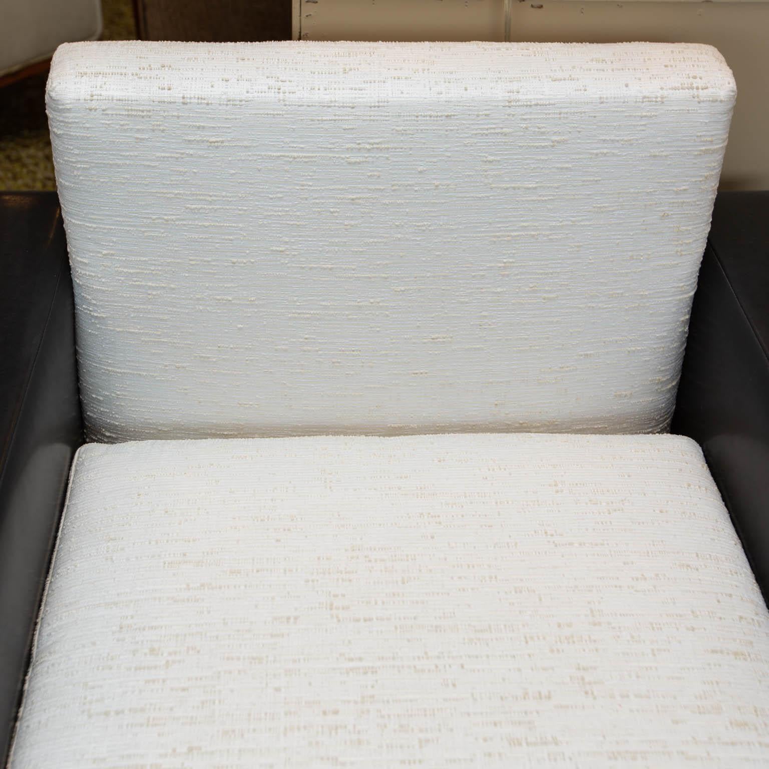Custom made set of leather club chairs with cushions and backs upholstered in white raw silk. Great contrast that fits perfectly in today's monochromatic interiors. There are two sets available for a total of 4 chairs. Price is per pair.