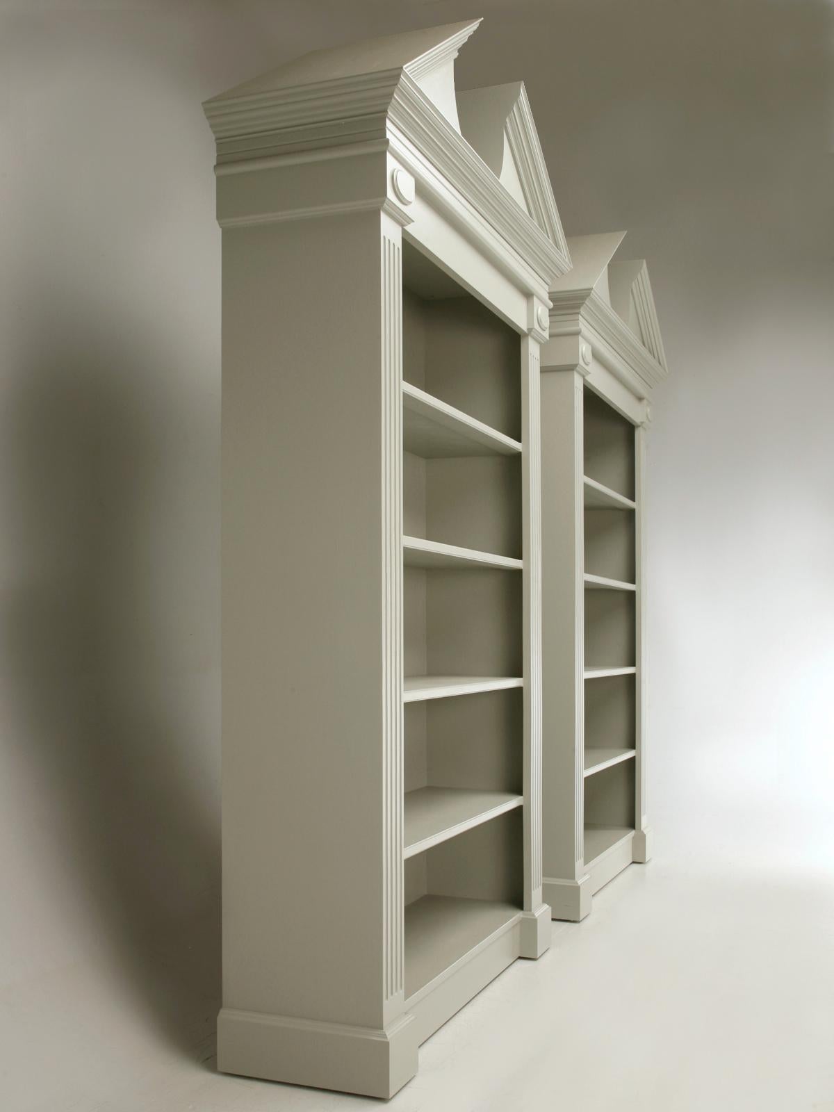 A stunning pair of custom bookcases made right here at our Old Plank workshop. These broken pediment handmade custom bookcases can be reproduced in any size and color and are made on-site with every attention to detail. Priced as a pair.