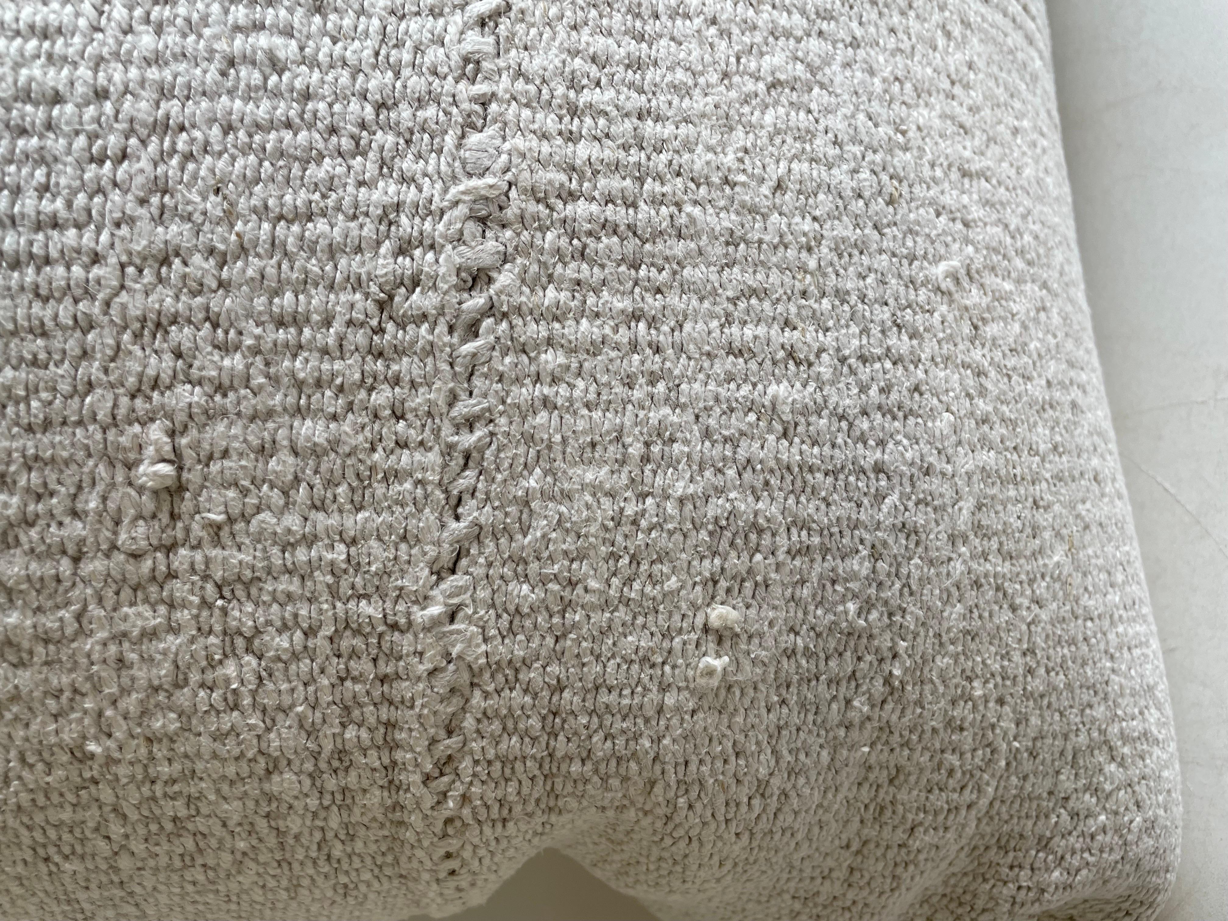 Cremefarbener weißer Hanfteppich im Patchwork-Stil. Einzigartiges Patchwork-Kissen, das aus Teilen verschiedener türkischer Teppiche in verschiedenen Weißtönen hergestellt wurde. Fester Stoff auf der Rückseite und verdeckter Reißverschluss. Es wird