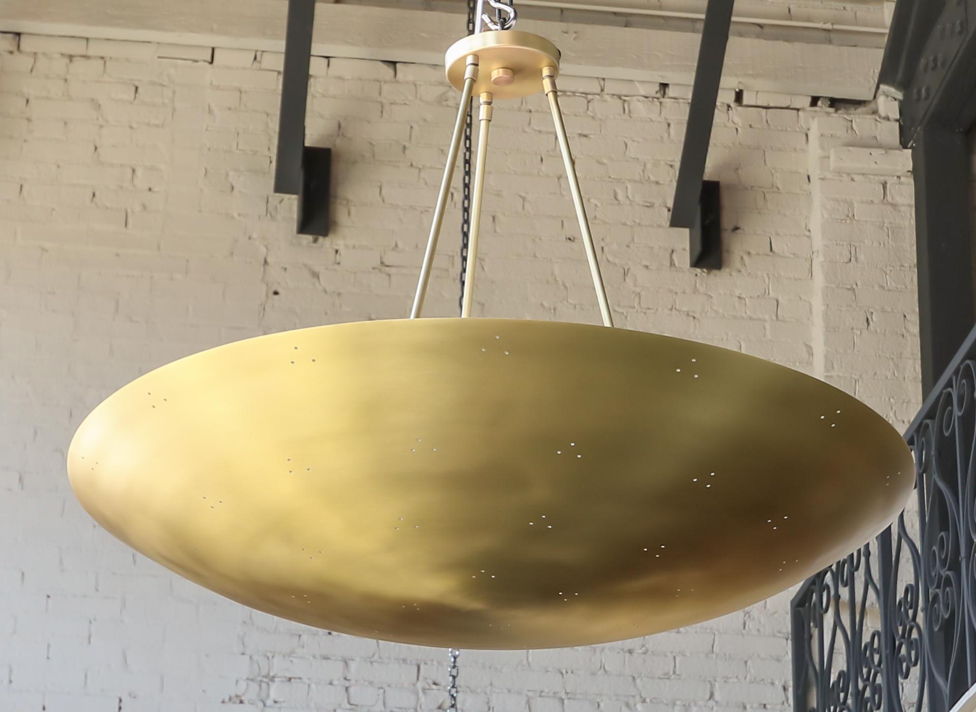 Custom conical /convex shaped pendant chandelier in perforated brass. Can be done in different sizes and finishes.