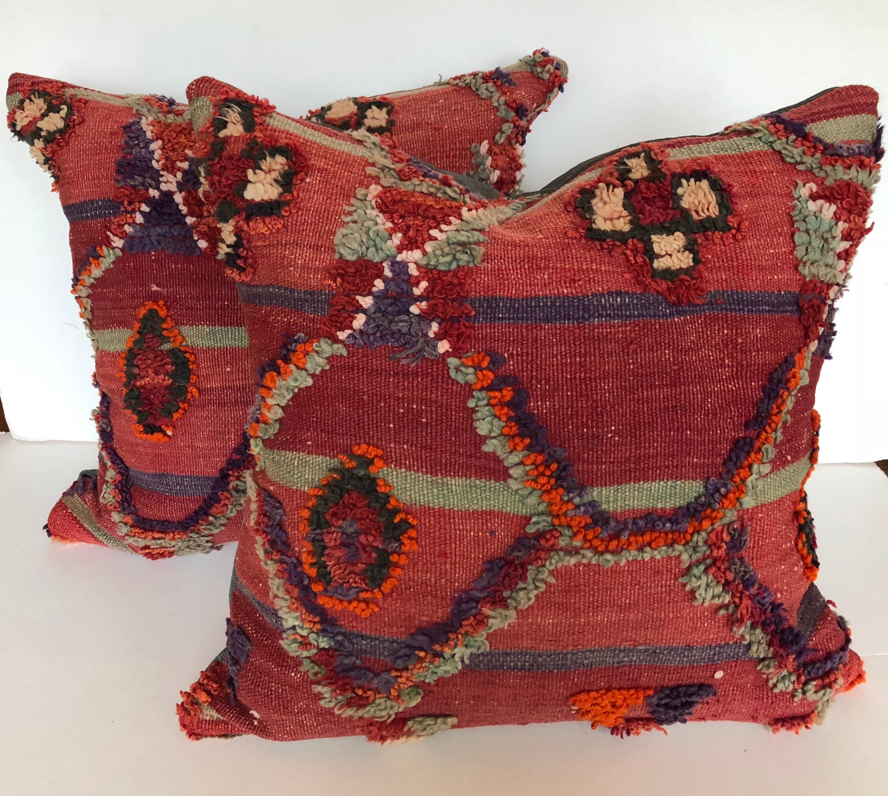 Custom pillow cut from a vintage hand loomed wool Ait Bou Ichaouen Moroccan Berber rug, one of the most remote, isolated tribes in Morocco. Bold colors and patterns reflect an older North African tradition unlike those from elsewhere. The pillow is