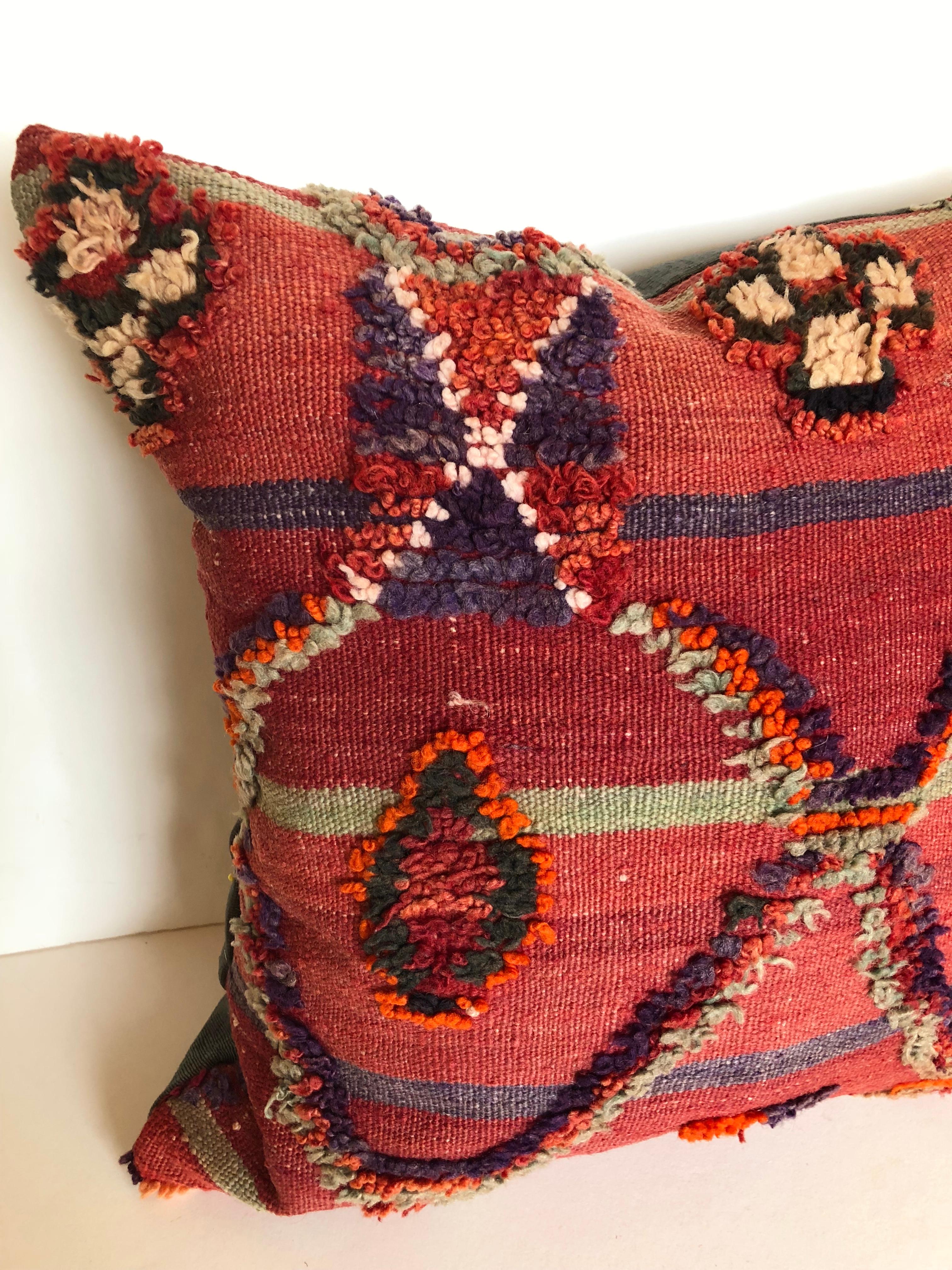 Custom pillow cut from a vintage hand loomed wool Ait Bou Ichaouen Moroccan Berber rug, one of the most remore, isolated tribes in Morocco. Bold colors and patterns reflect an older North African tradition unlike those from elsewhere. The pillow is