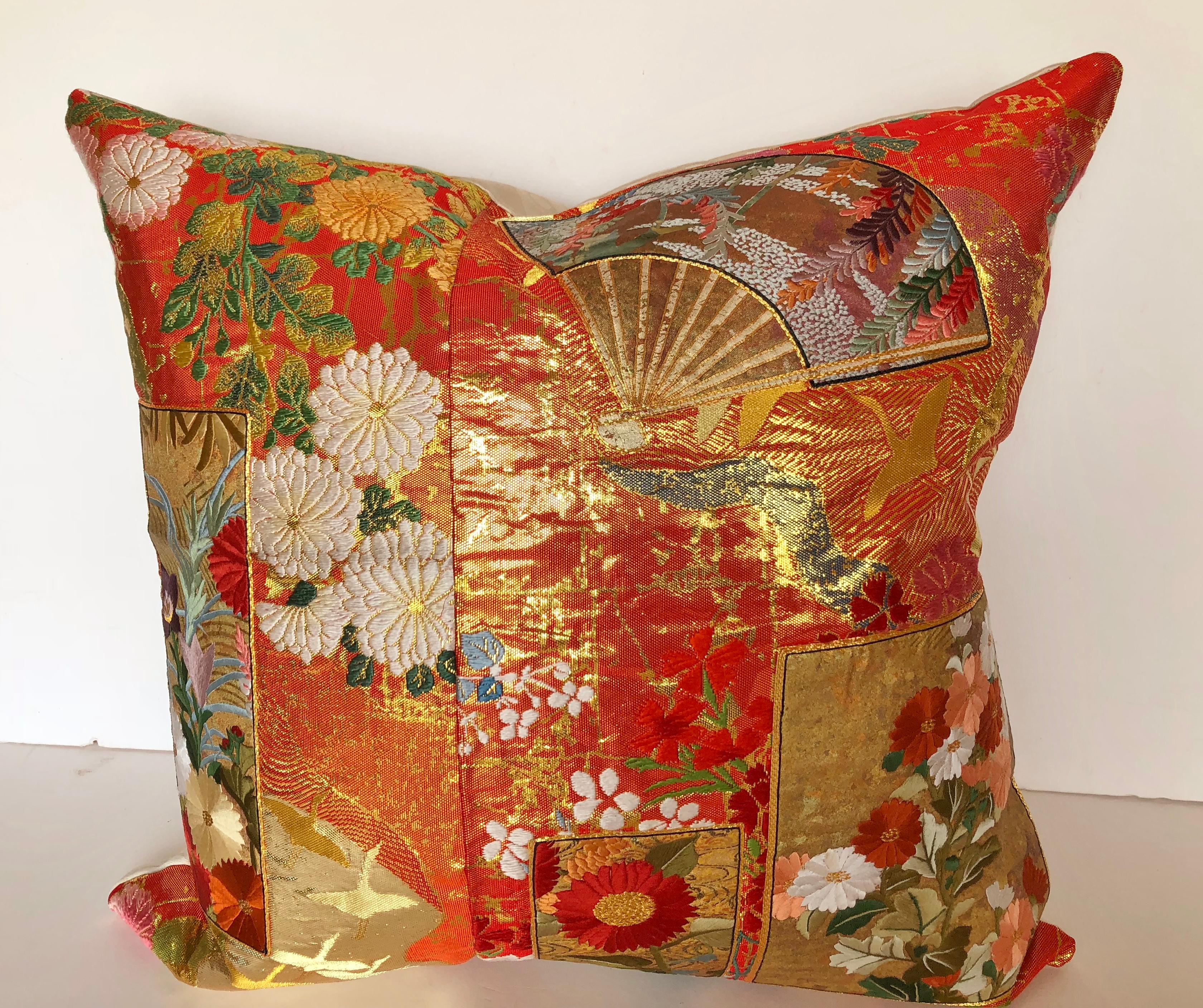 Custom pillow cut from a vintage silk Japanese Uchikake, the traditional wedding kimono. The background of the textile has the traditional design of florals and birds with silk and metallic threads. Embroidered silk appliques with fans and florals