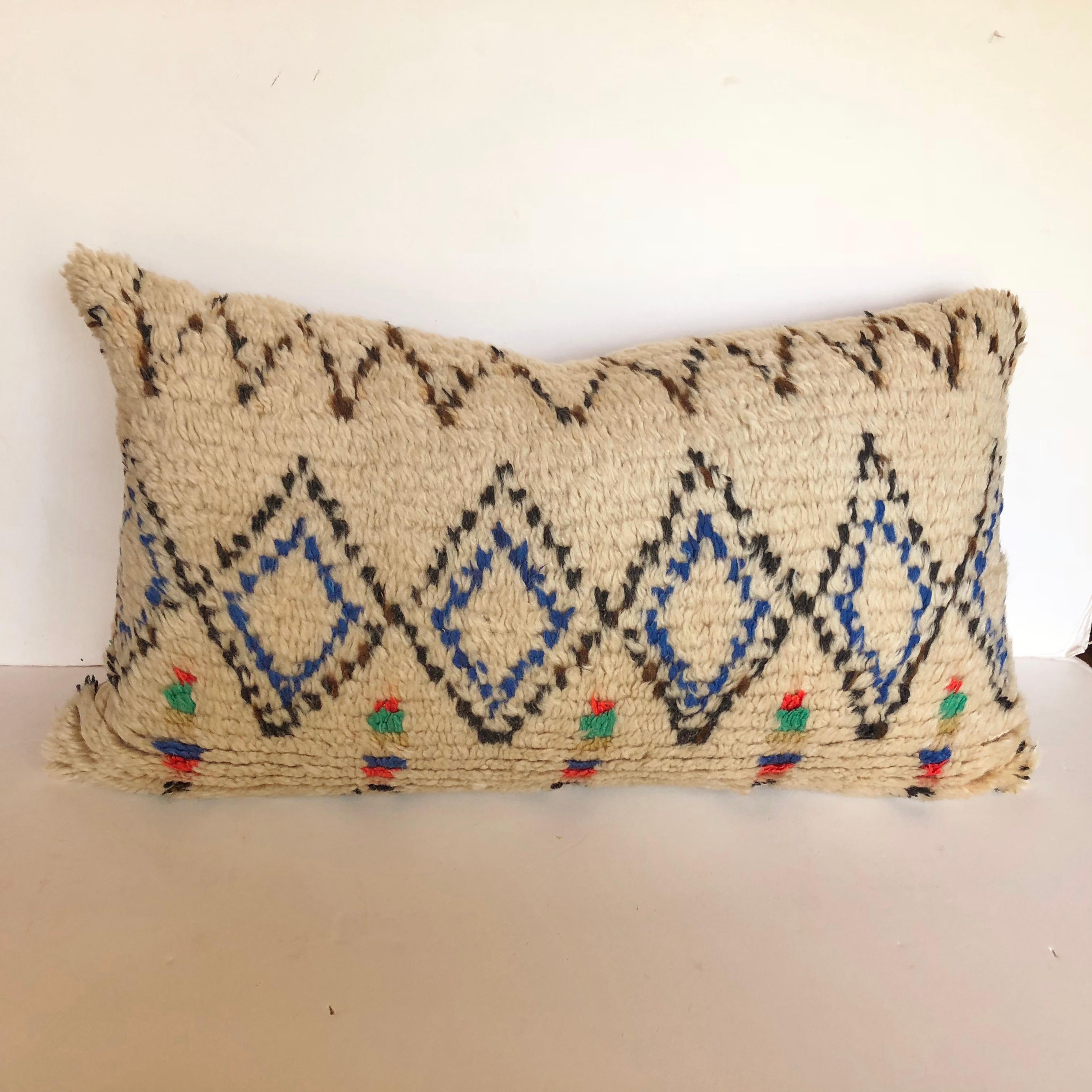Custom pillow cut from a vintage hand loomed wool Moroccan Azilal rug from the Atlas Mountains. Wool is soft and lustrous with all natural dyes. Pillow is backed in cream mohair, filled with an insert of 100% down and hand sewn closed. We make all