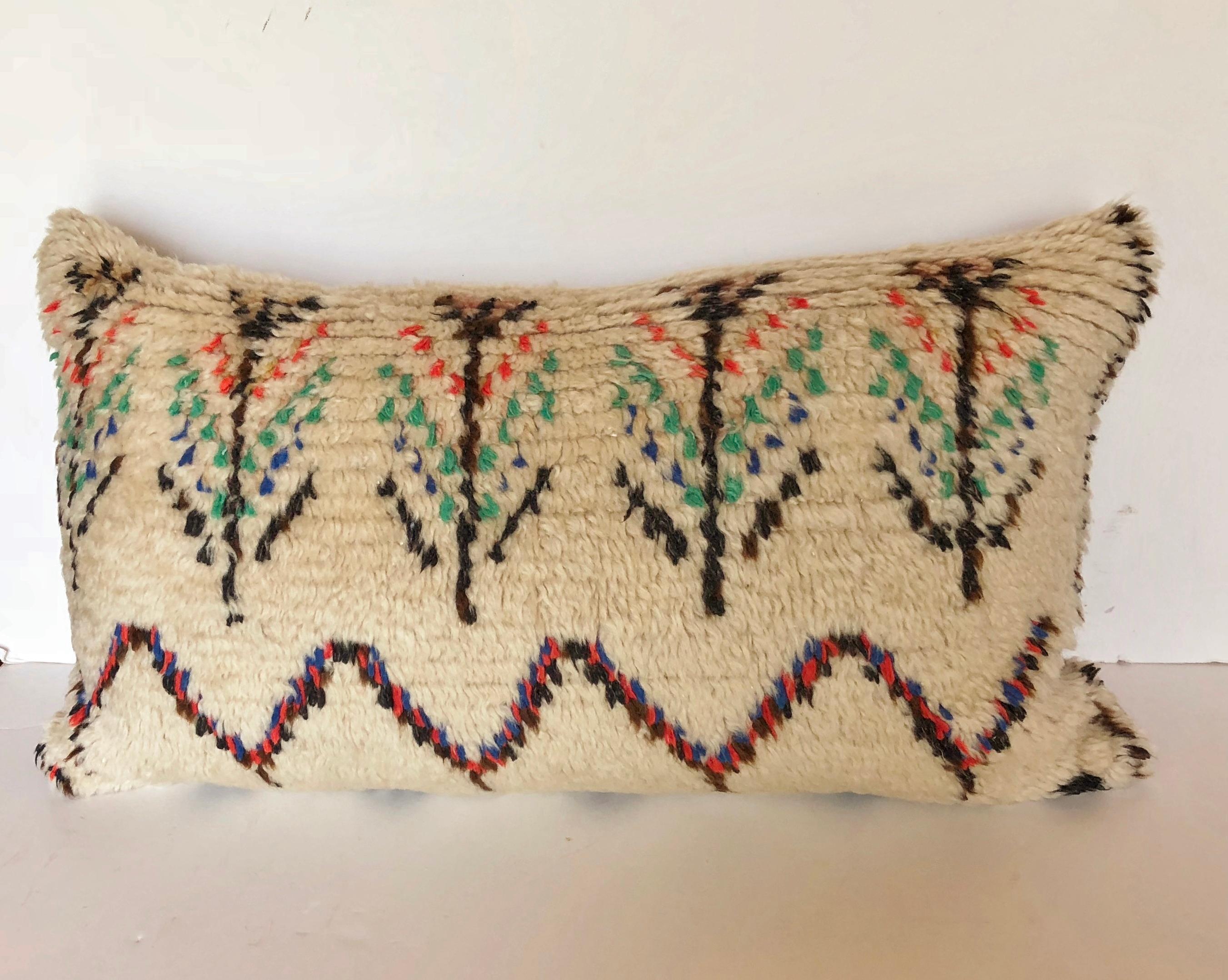 Custom pillow cut from a vintage hand loomed wool Moroccan Azilal rug from the Atlas Mountains. Wool is soft and lustrous with all natural dyes. Pillow is backed in cream mohair, filled with a 100% down insert and hand sewn closed. We make all of