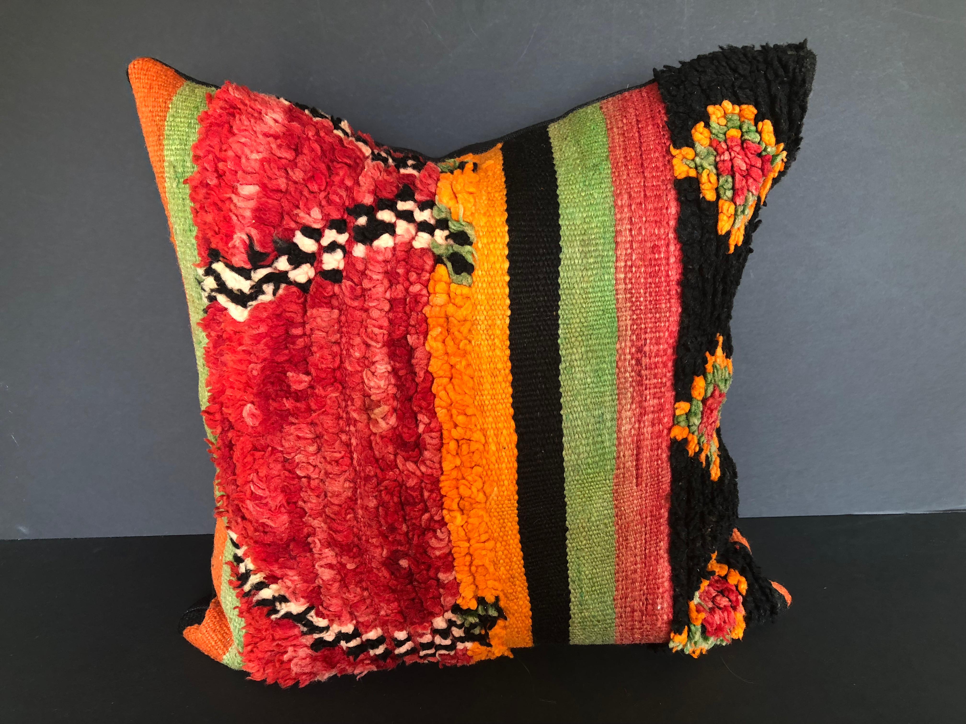 Custom pillow cut from a vintage hand loomed wool Moroccan Ait Bou Ichaouen Berber rug, one of the most isolated tribes in the Atlas Mountains. Bold striking colors and patterns reflect an older North African tradition unlike those found elsewhere.