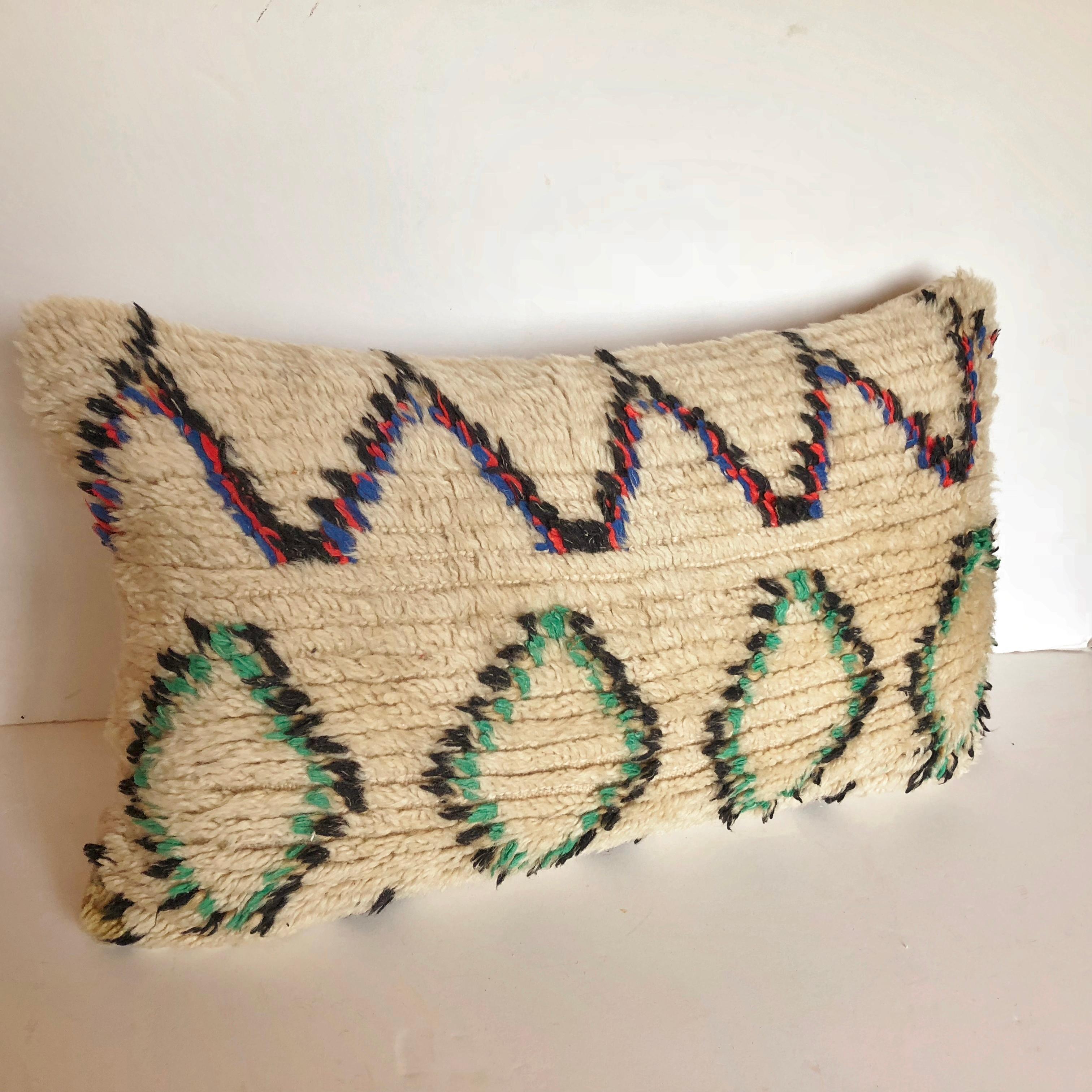 Custom pillow cut from a vintage hand loomed wool Moroccan Azilal rug from the Atlas Mountains. Wool is soft and lustrous with all natural dyes. Pillow is backed in creamy mohair, filled with 100% down and hand sewn closed. We make all of our