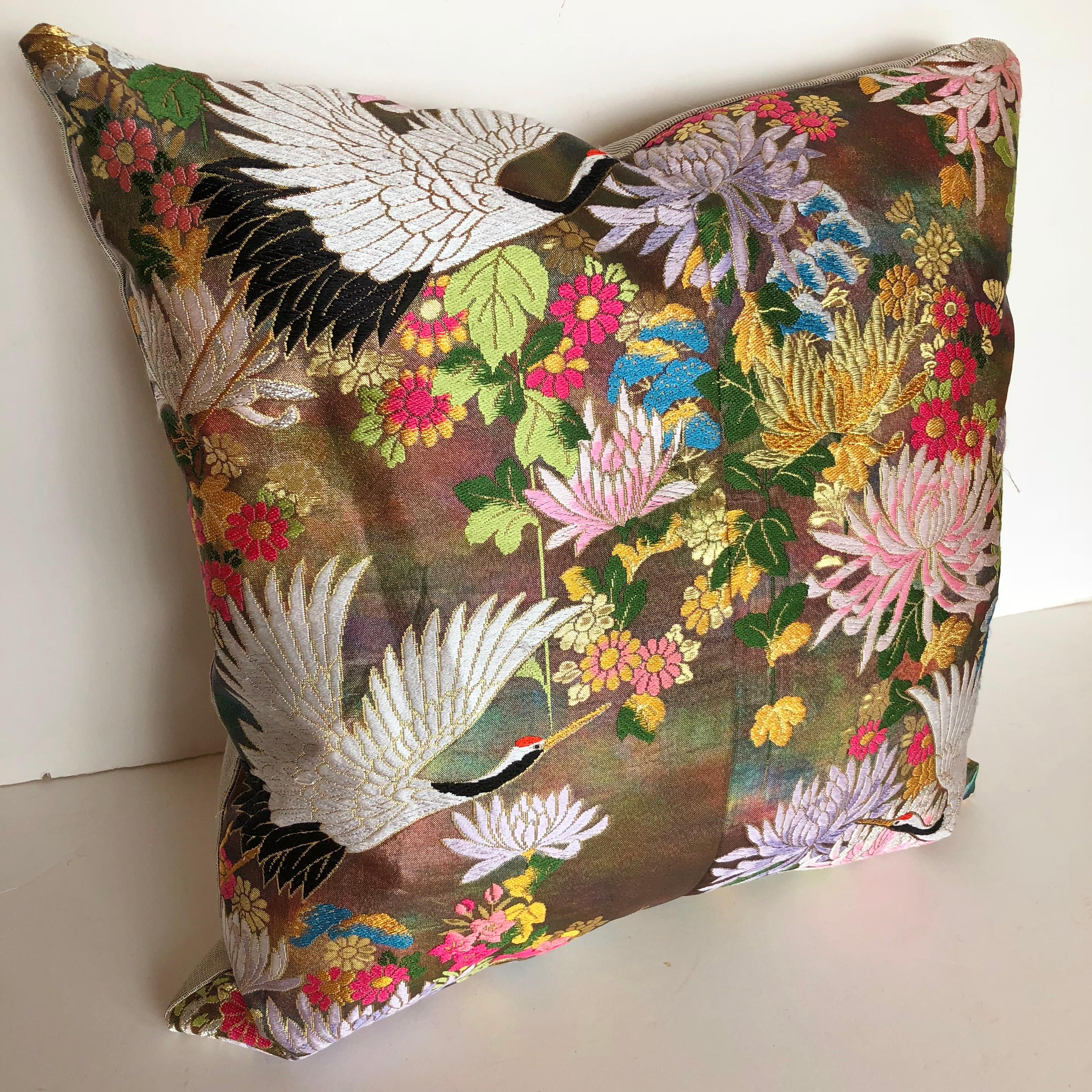 Custom pillow cut from a vintage Japanese silk Uchikake, the traditional wedding kimono. The silk textile has a floral design in vibrant colors with embroidered birds. The pillow is backed in a soft silk stripe, filled with an insert of 50/50 down