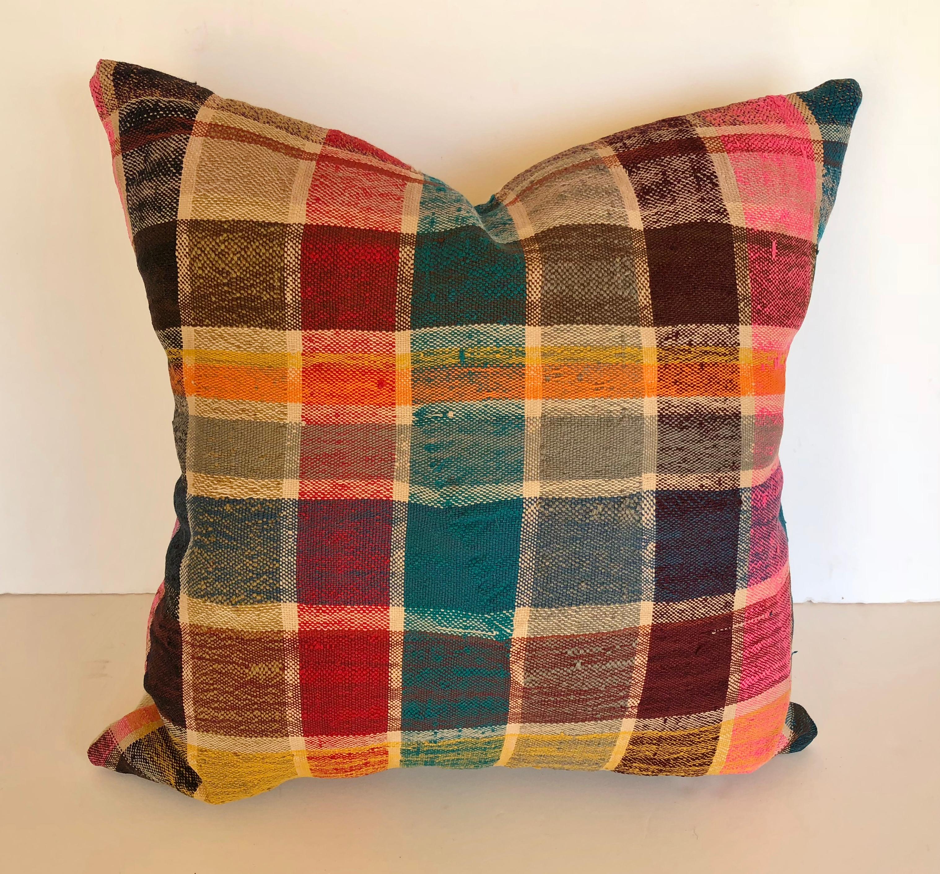 Custom pillow cut from a vintage Moroccan hand loomed cotton haik or Berber shawl from the Atlas Mountains. They are traditionally made in bright colored plaids. Pillow is backed in a linen blend, filled with an insert of 50/50 down and feathers and