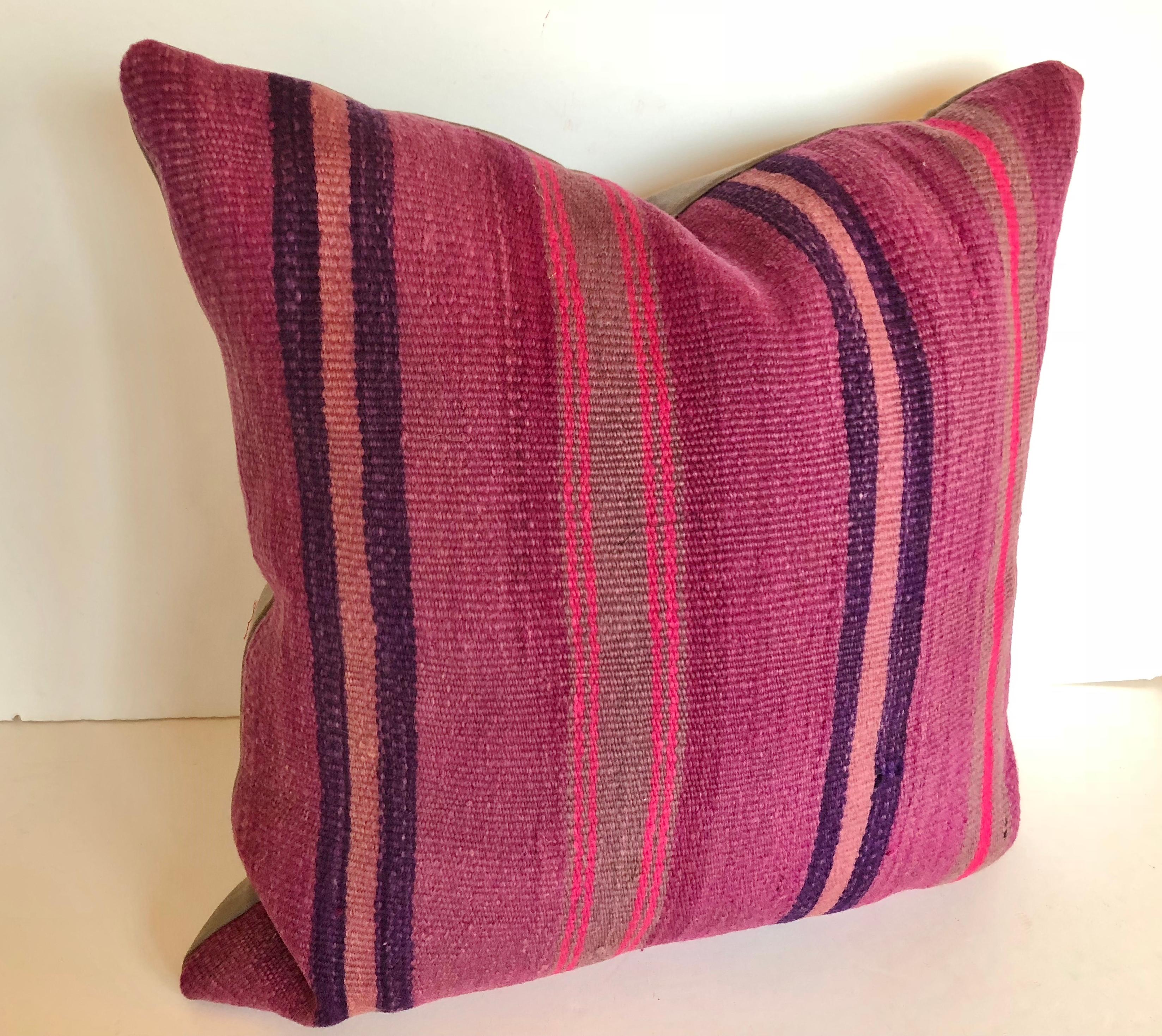 Custom pillow cut from a vintage Moroccan hand loomed wool Berber rug from the Atlas Mountains. Wool is soft and lustrous with stripes in shades of purple, navy and rose. Pillow is filled with an insert of 50/50 down and feathers, backed in a wool