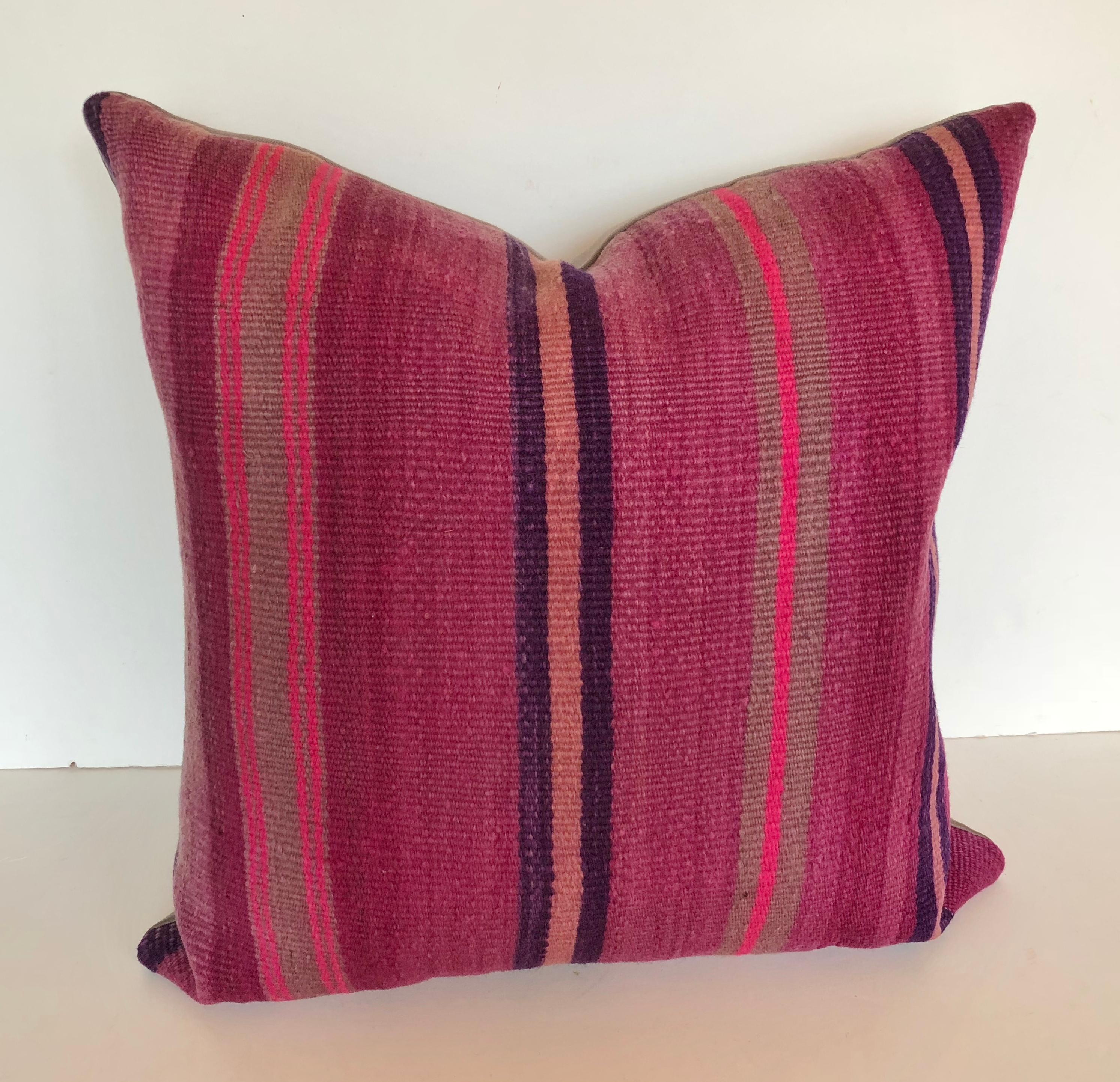 Custom pillow cut from a vintage Moroccan hand-loomed wool Berber rug from the Atlas Mountains. Wool is soft and lustrous with stripes in shades of purple. Pillow is backed in a wool blend, filled with an insert of 50/50 down and feathers and hand
