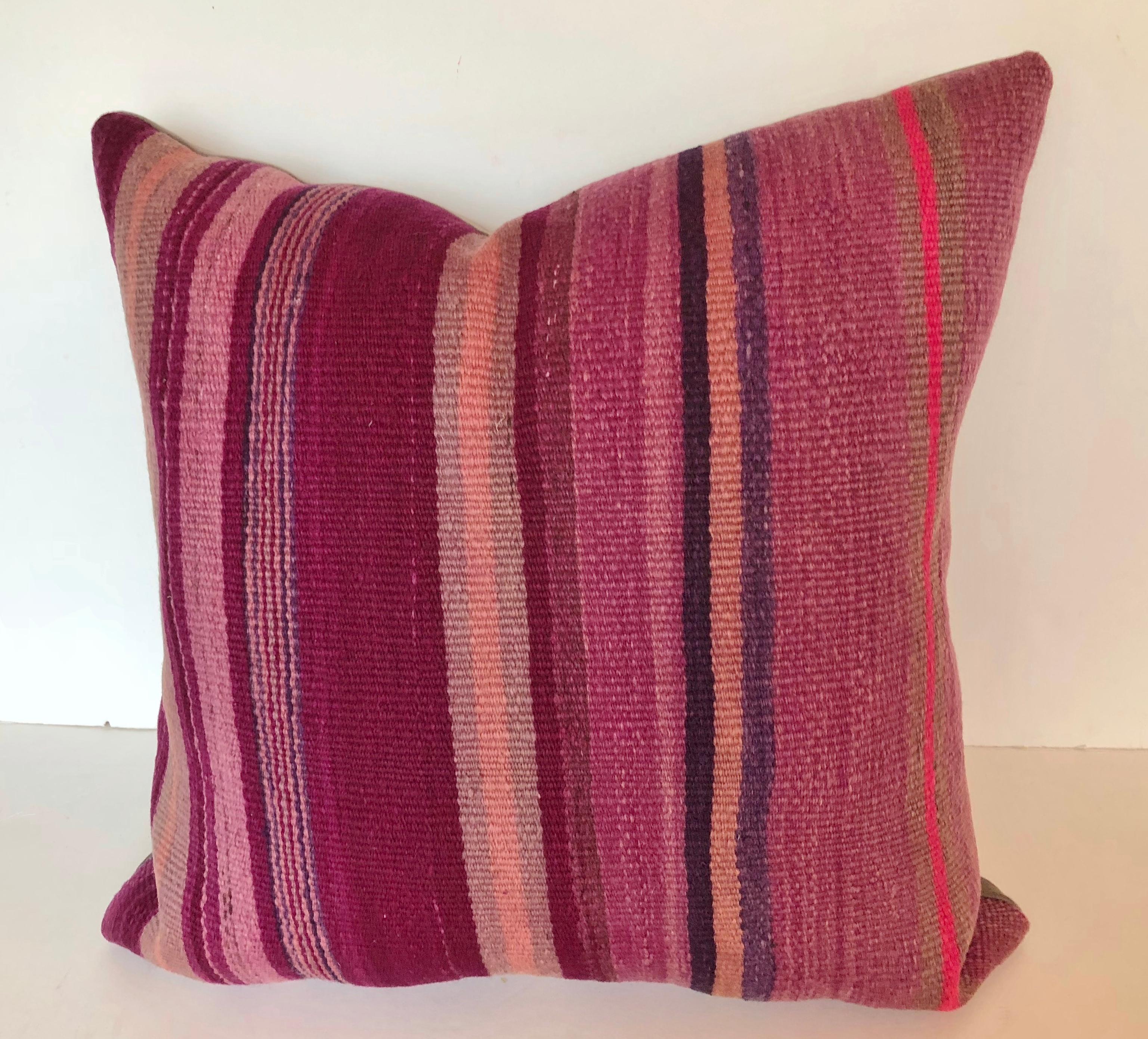 Custom pillow cut from a vintage Moroccan hand loomed wool Berber rug from the Atlas Mountains. Wool is soft and lustrous with vivid stripes in shades of purple. Pillow is filled with an insert of 50/50 down and feathers, backed in a wool blend and