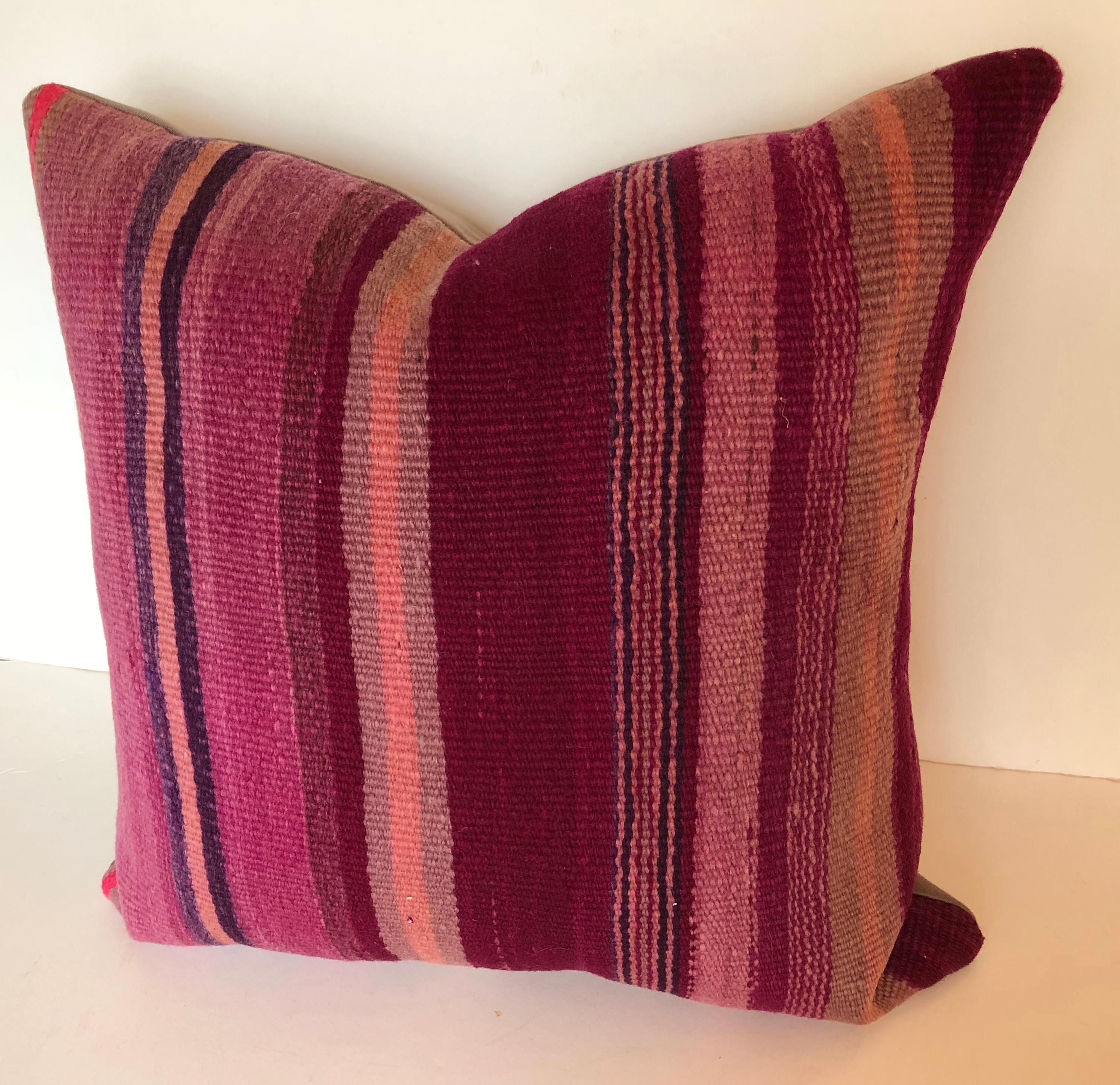 Custom pillow cut from a vintage Moroccan hand loomed wool Berber rug from the Atlas Mountains. Wool is soft and lustrous with stripes in shades of purple. Pillow is backed in a wool blend, filled with an insert of 50/50 down and feathers and hand
