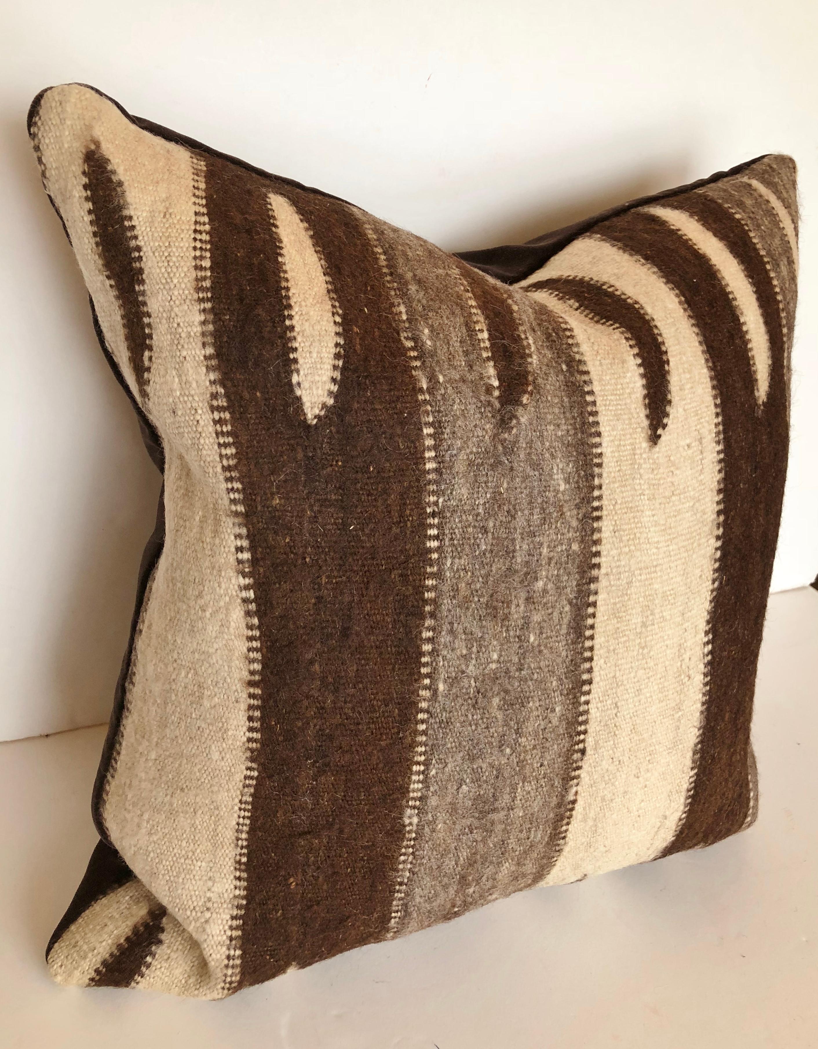 Custom pillow cut from a vintage hand loomed wool Moroccan Rug from the Ourika Valley, Upper Atlas Mountains. Thickly woven wool is soft and lustrous with natural colors. Pillow is backed in dark brown velvet, filled with an insert of 50/50 down and