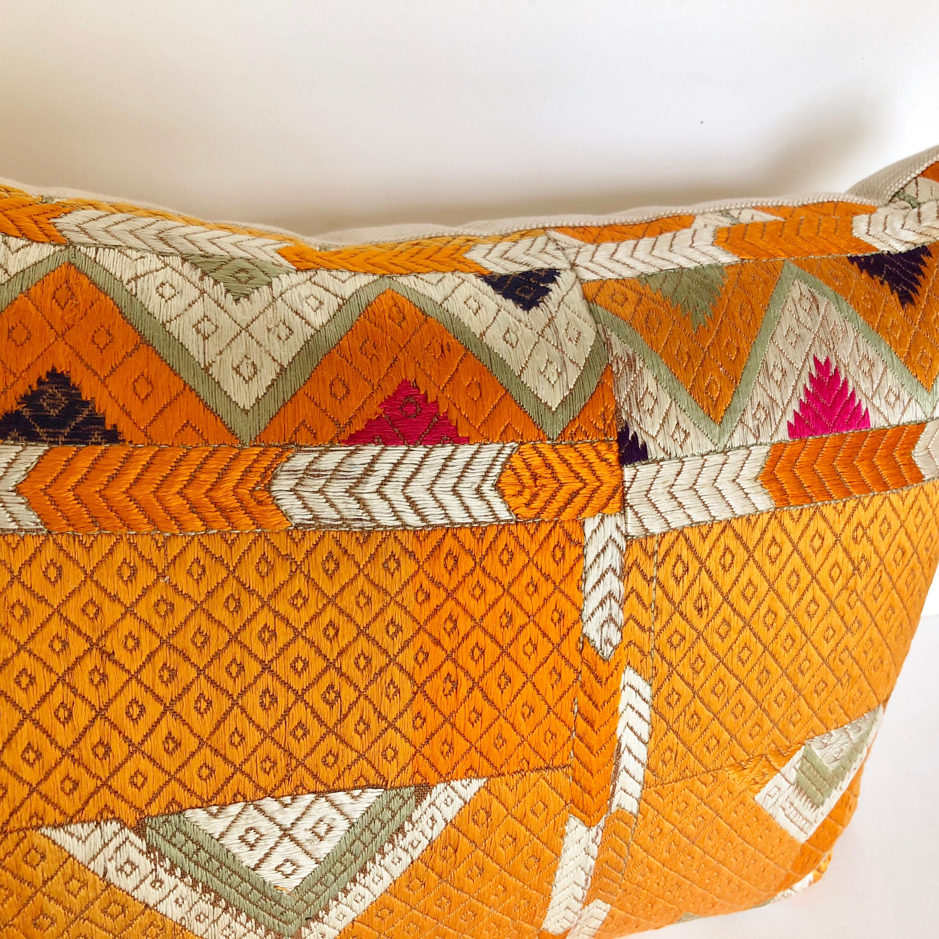 Custom pillow cut from a vintage Phulkari Bagh wedding shawl from Punjab, India. The handwoven cotton Khadi cloth is hand embroidered with vibrant silk threads by members of the young girl's family. The pillow is backed in an ivory silk, filled with
