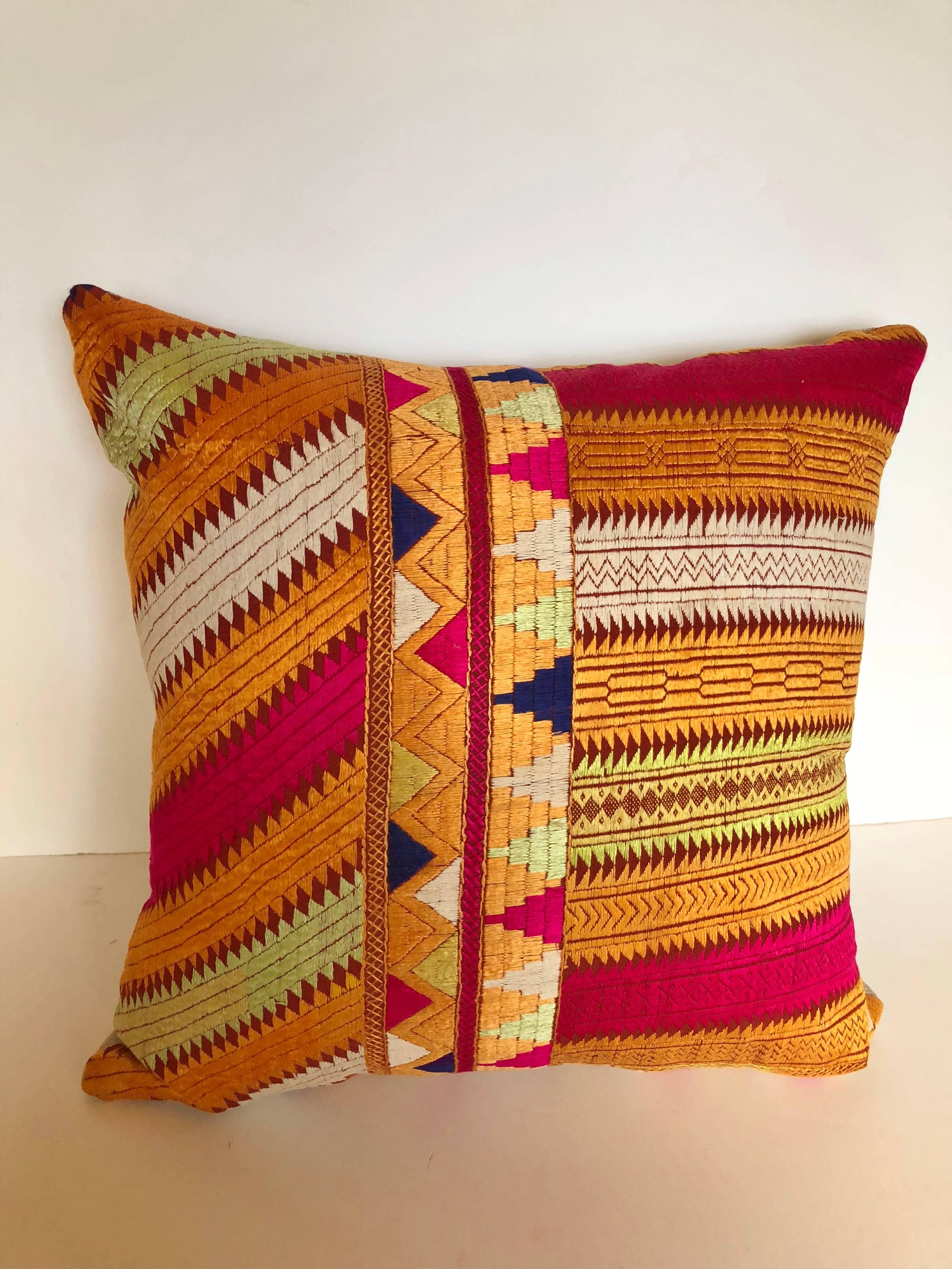 Custom pillow cut from a vintage silk embroidered Phulkari Bagh wedding shawl from Punjab, India. Relatives of the young girl would embroider hand loomed cotton khadi cloth with brightly colored silk threads in traditional designs. The pillow is