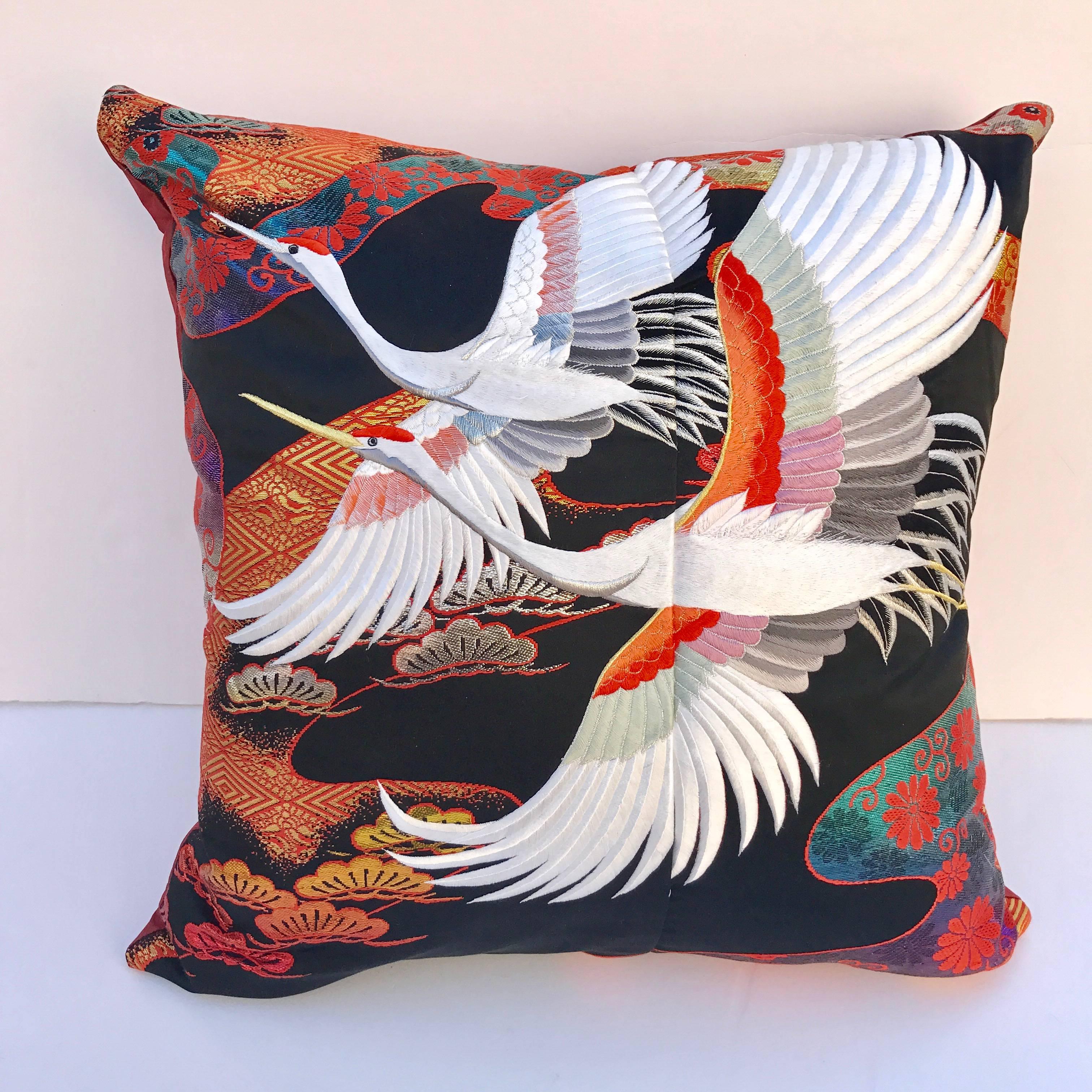 Custom pillow cut from a vintage Japanese silk Uchikake, the traditional wedding kimono. The black silk is embellished with vibrant designs and embroidered birds. The pillow is backed in silk, filled with an insert of 50/50 down and feathers and