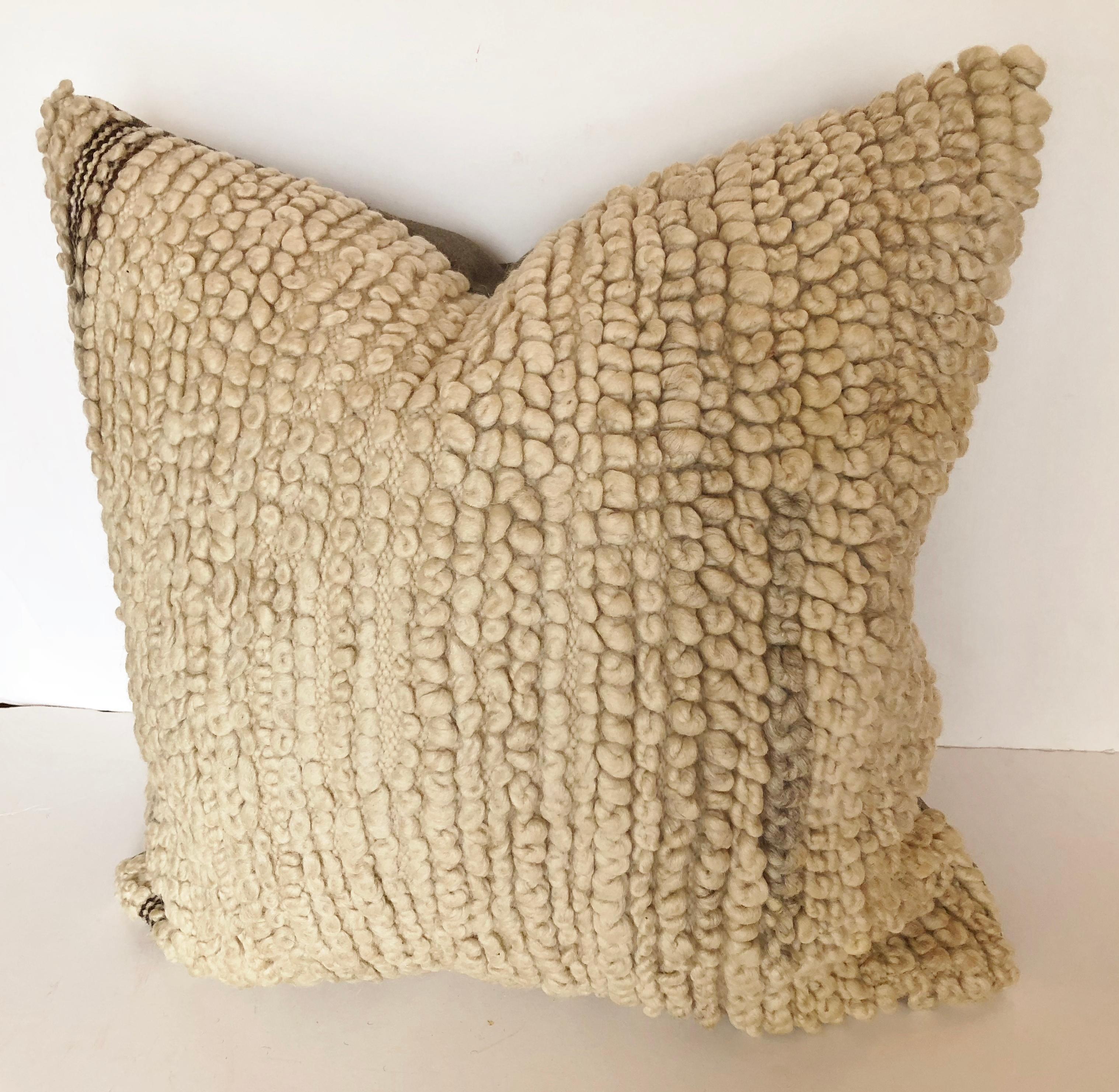 Custom pillow cut from a vintage handwoven wool Moroccan Beni Ouarain rug from the Atlas Mountains. Wool is soft and lustrous with all natural color. Pillow is backed in a wool blend, filled with an insert of 50/50 down and feathers and hand sewn