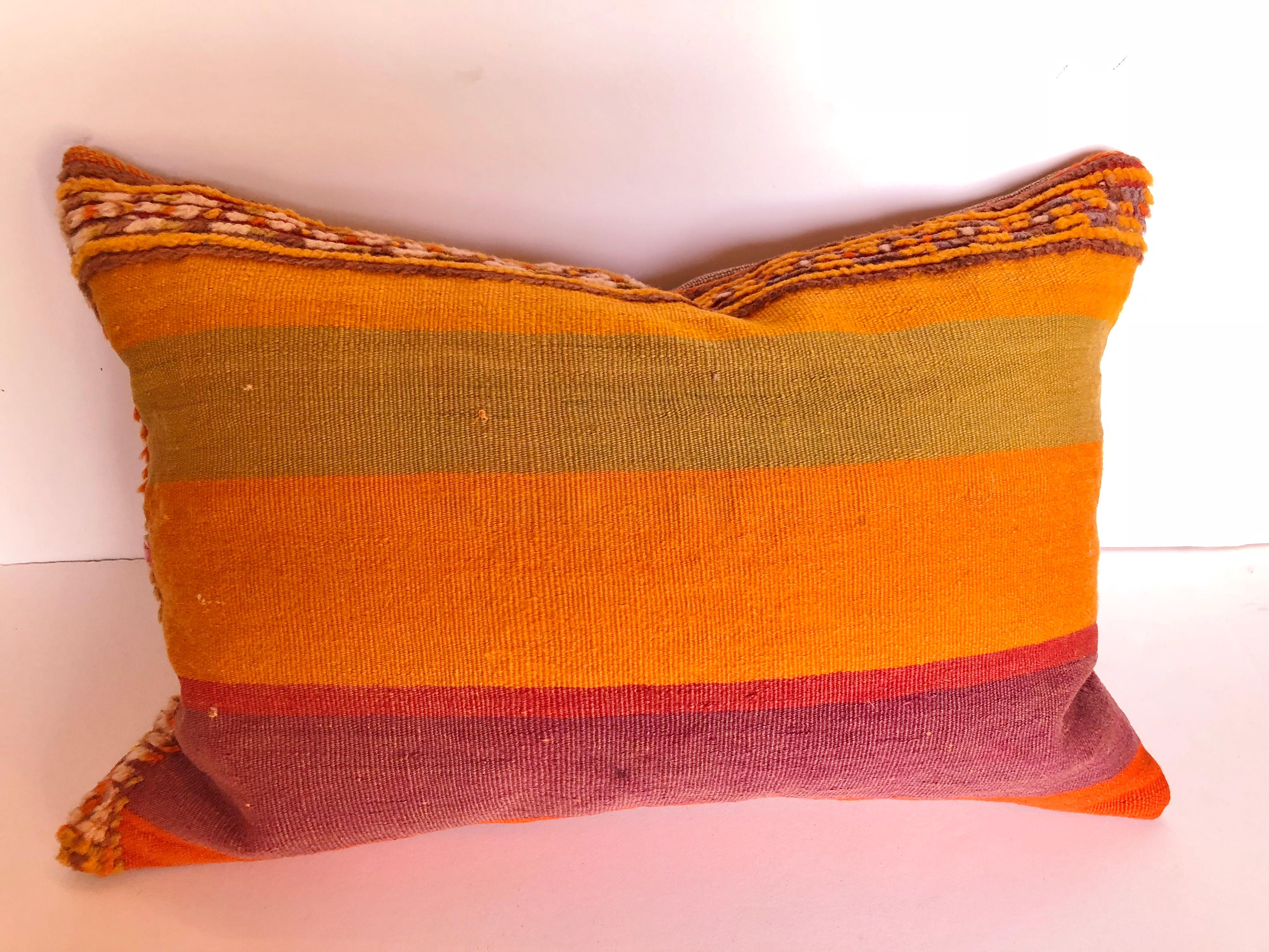 Custom pillow cut from a vintage hand-loomed wool Moroccan rug, made in the Atlas Mountains. Vivid stripes with tufted bands. Pillow is backed in linen, filled with an insert of 100% down and hand sewn closed. We make all of our pillows from the