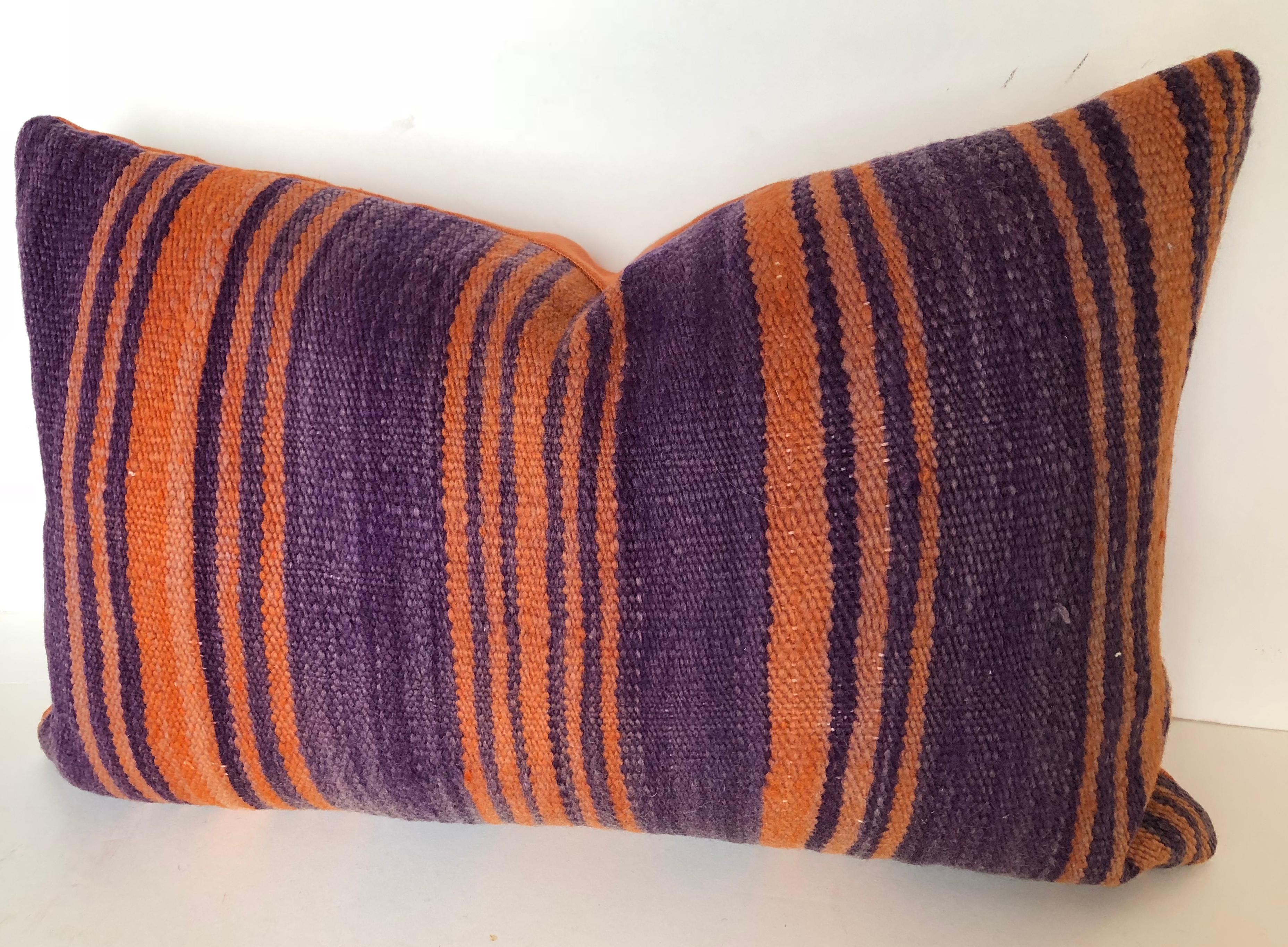 Custom pillow cut from a vintage hand-loomed wool Moroccan Berber rug from
the Atlas Mountains. Wool is soft and lustrous with good color in shades of purple and apricot. Pillow is backed in apricot linen, filled with an insert of 100% down and