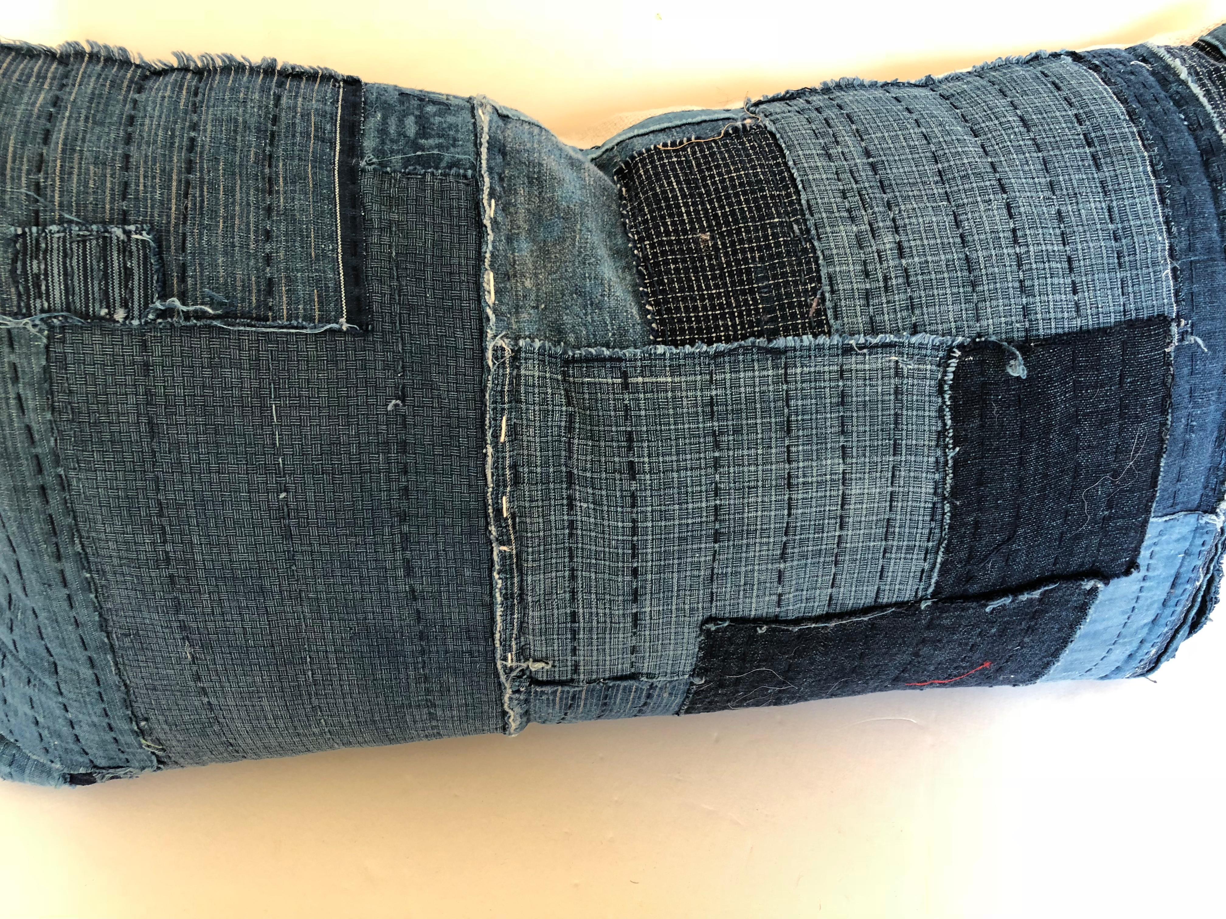 Custom pillow cut from an antique Japanese futon cover made from hand loomed cotton indigo, circa early 1900s. In some places there are up to 6 layers of worn fabric stitched together with Sashiko stitching. All textiles have been washed. Made for