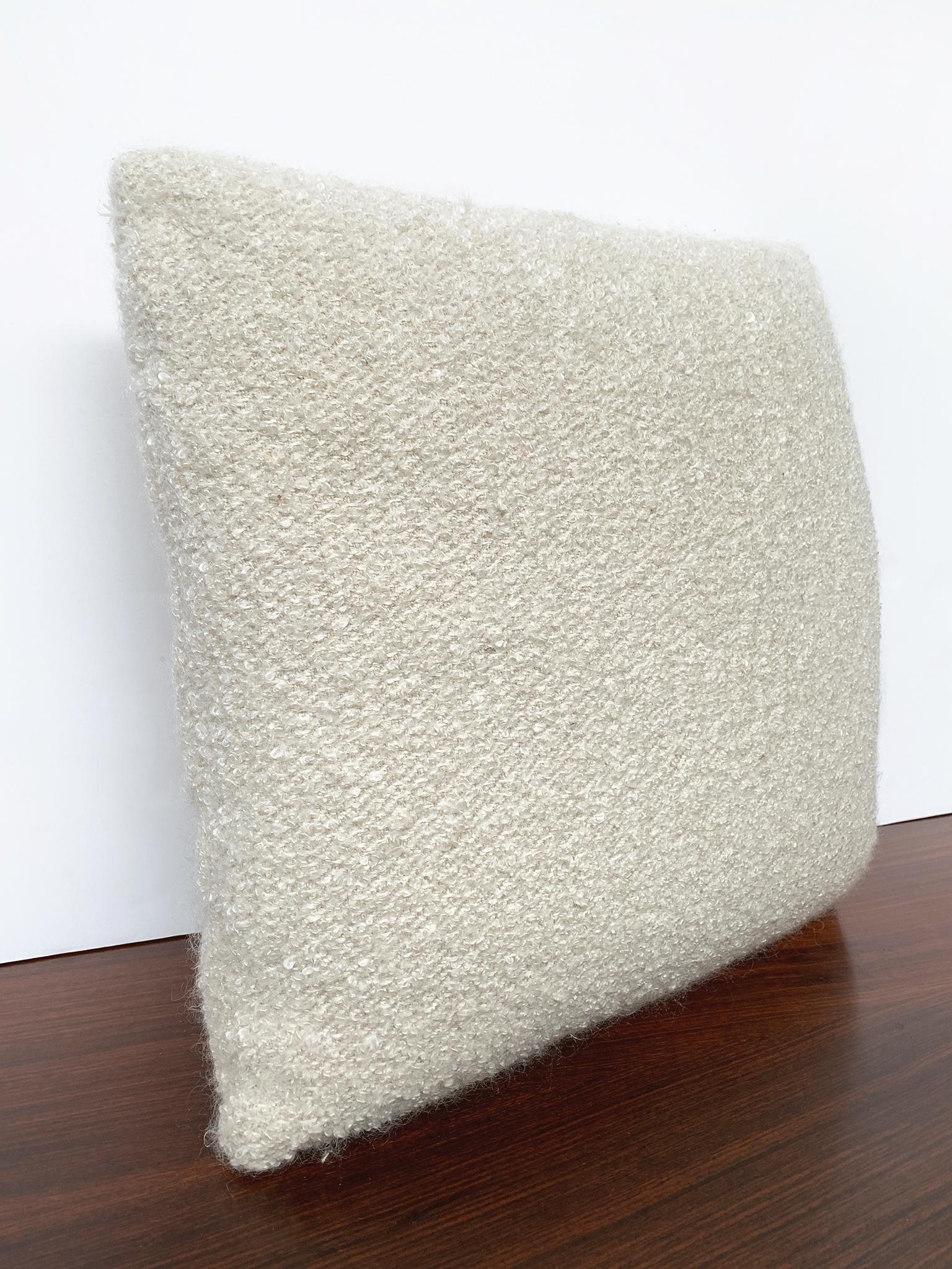 New custom made pillow with a bouclé fabric from Schumacher. The bouclé is soft-textured and has a warm cream-white color. The filling is a combination of foam and down. This is an ideal pillow for lounging comfortably in your sofa or bed. There are