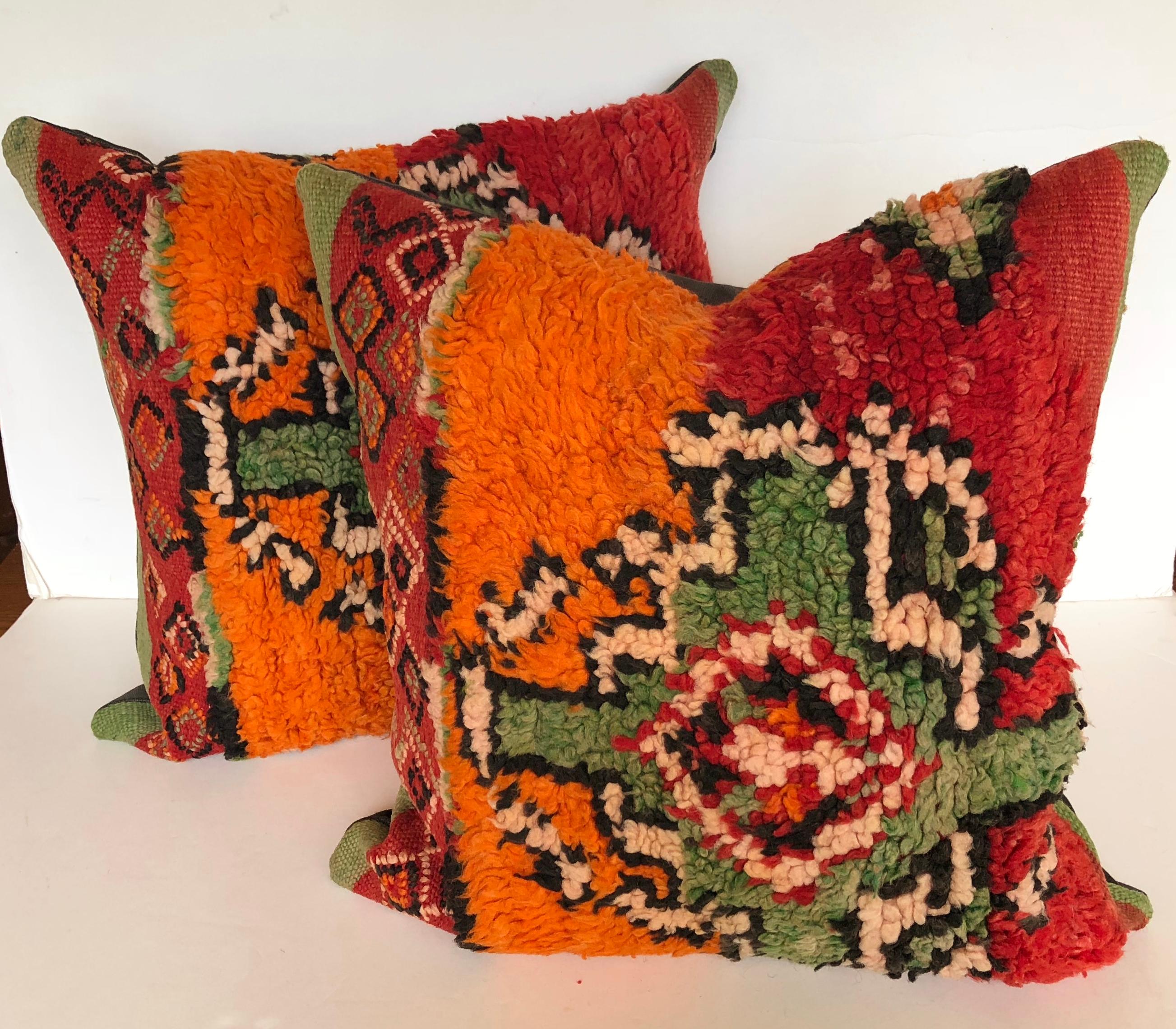 Custom pillows cut from a vintage hand loomed wool Ait Bou Ichaouen Moroccan Berber rug, one of the most remote, isolated tribes in Morocco. Bold striking colors and patterns reflect an older North African tradition unlike those from elsewhere.