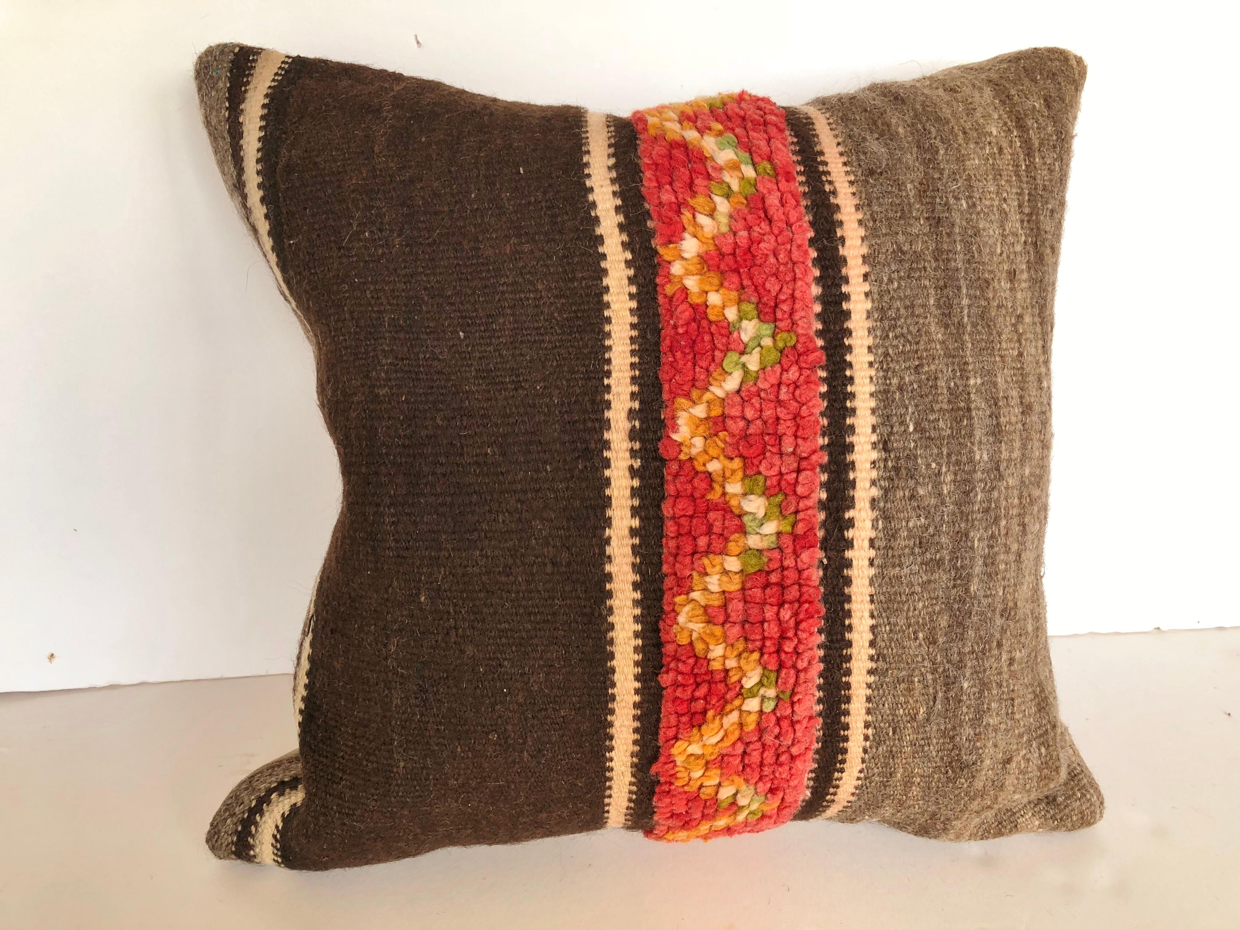 Custom Pillows by Maison Suzanne cut from a vintage hand loomed wool Moroccan Berber rug from the Atlas Mountains.  Wool with stripes in natural colors is embellished with colorful tufted bands.  Pillows are backed in velvet, filled with inserts of