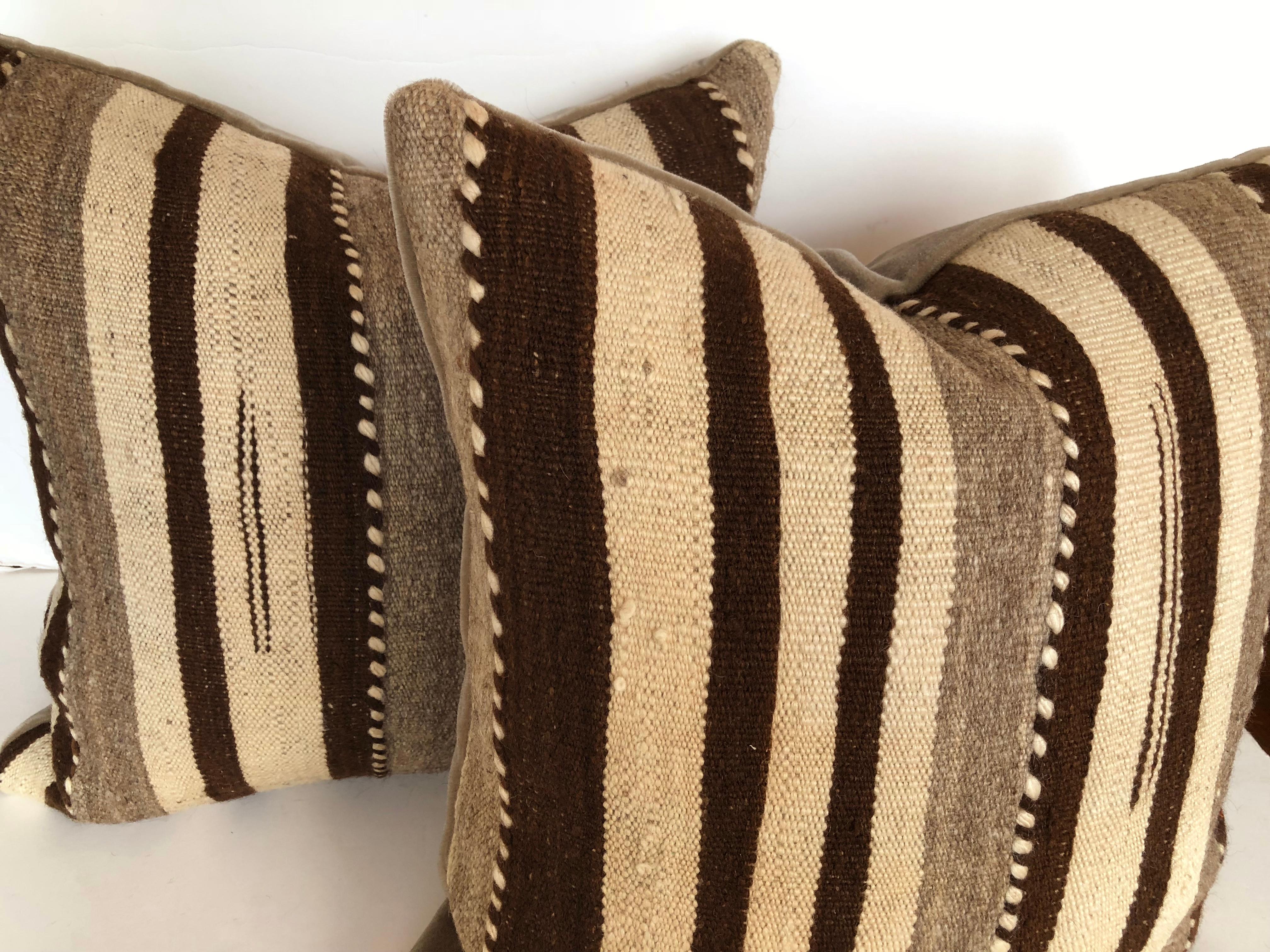 Custom pillows cut from a vintage hand loomed wool Moroccan Berber rug from the Atlas Mountains. Wool is soft and lustrous with all natural color. Pillow is backed in mohair, filled with an insert of 50/50 down and feathers and hand sewn closed.