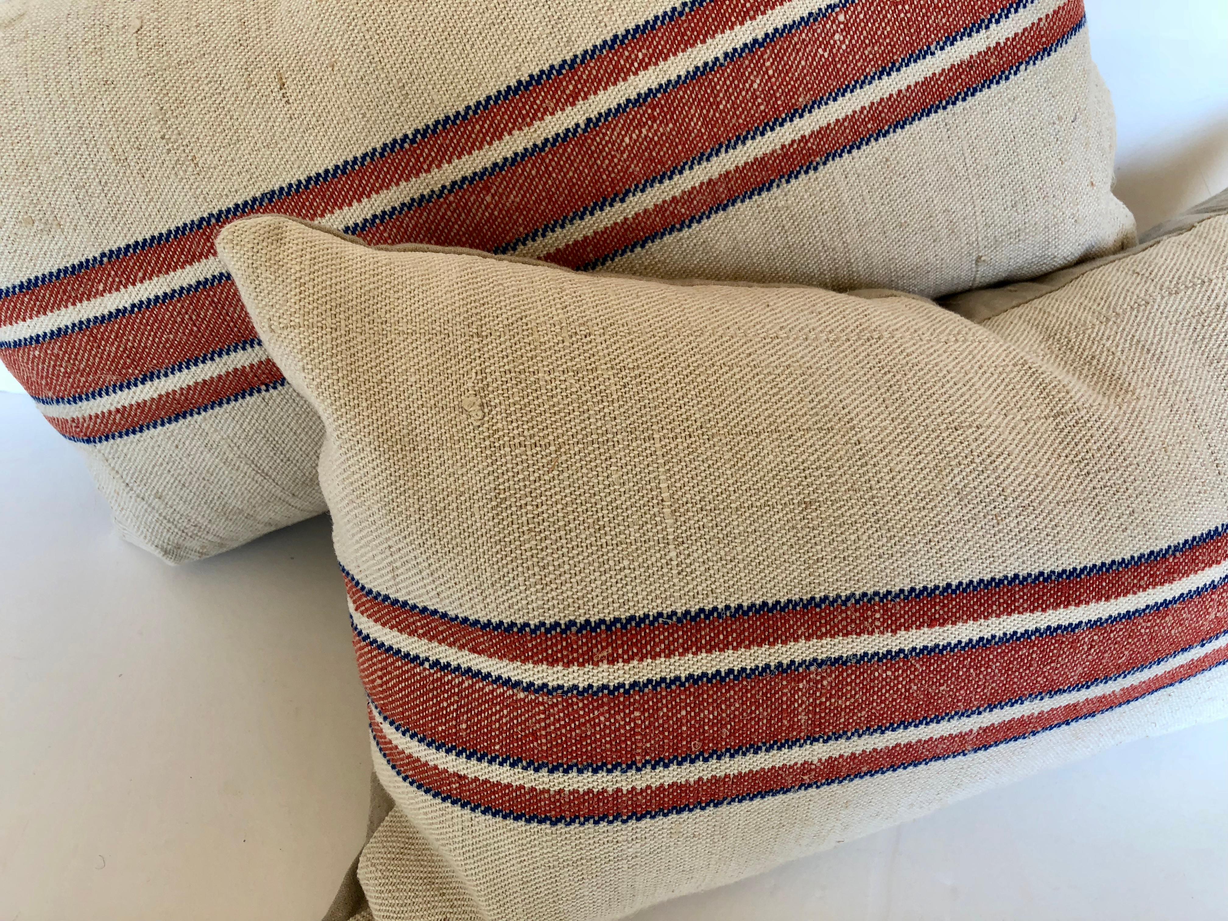 Custom pillows cut from a hand loomed hemp and linen German grain sack. Made by the farmer's wife to store grains in the barn. The bag has been laundered to remove any remnants of grain in the seams. The pillows are backed in a cream hand loomed