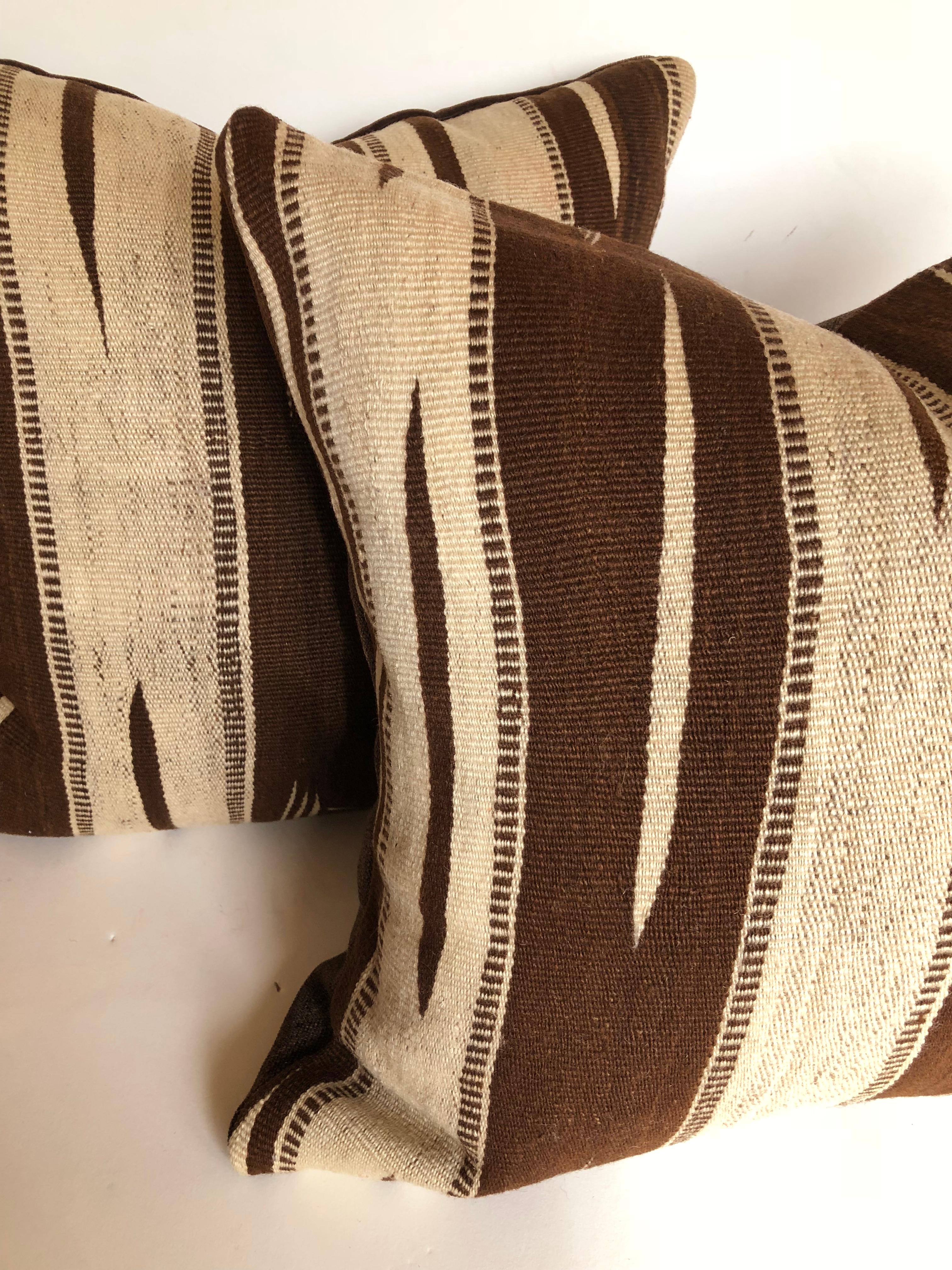 Custom pillows cut from a vintage Moroccan hand loomed wool rug from the Ourika Valley, Atlas Mountains. Rugs are make for the maker's personal use, not the commercial market. Wool is soft and lustrous with stripes with a tribal design in natural
