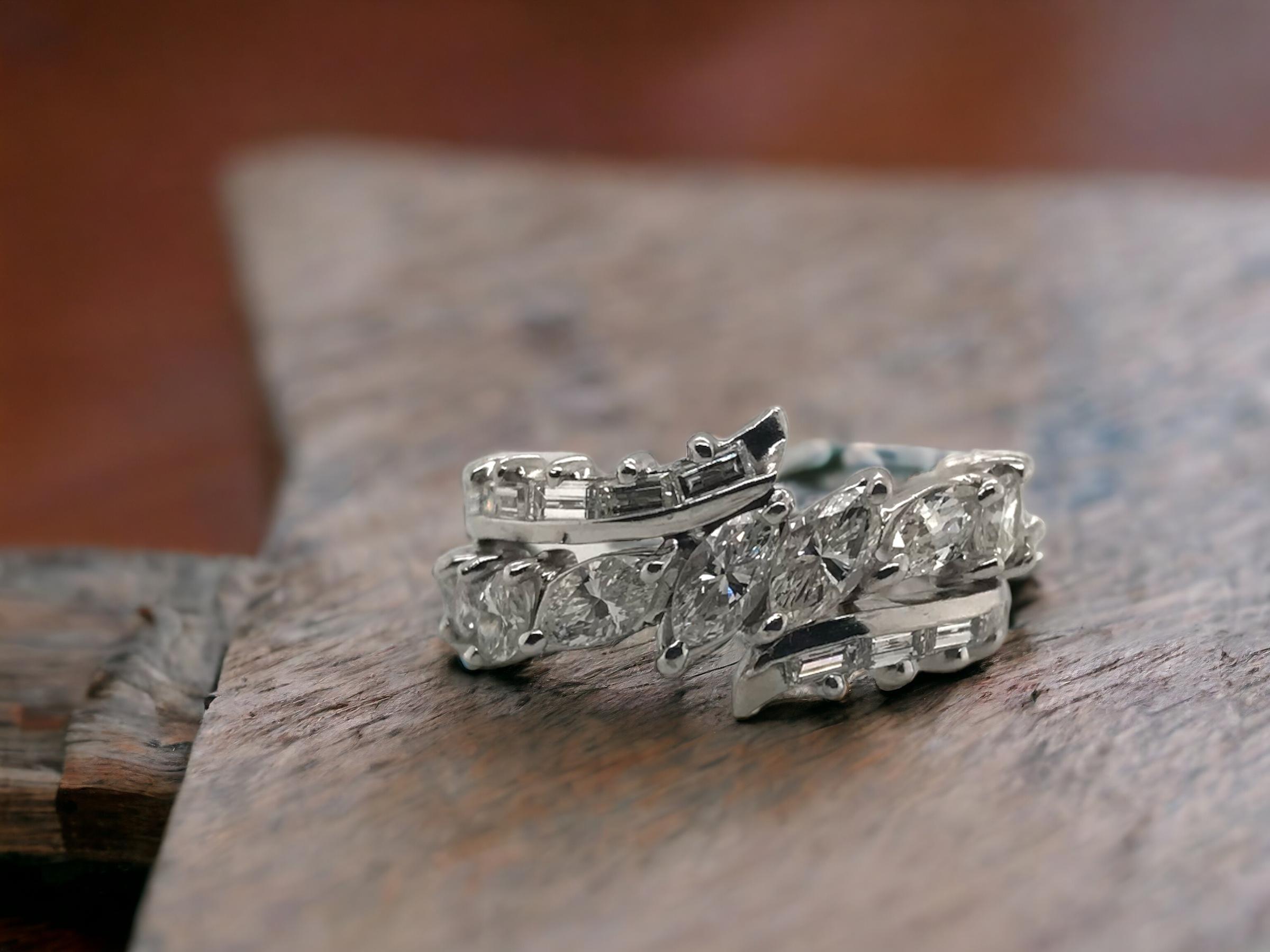 This lovely ring is definitely unique!
We love the combination & use of marquise cut diamonds.

Ring Details
Material: Platinum
Top Width: 11.2mm 
Weight: 6.7 Grams
Finger Size: 8
Sizable Upon Request

Accented by the following gemstones
10 -