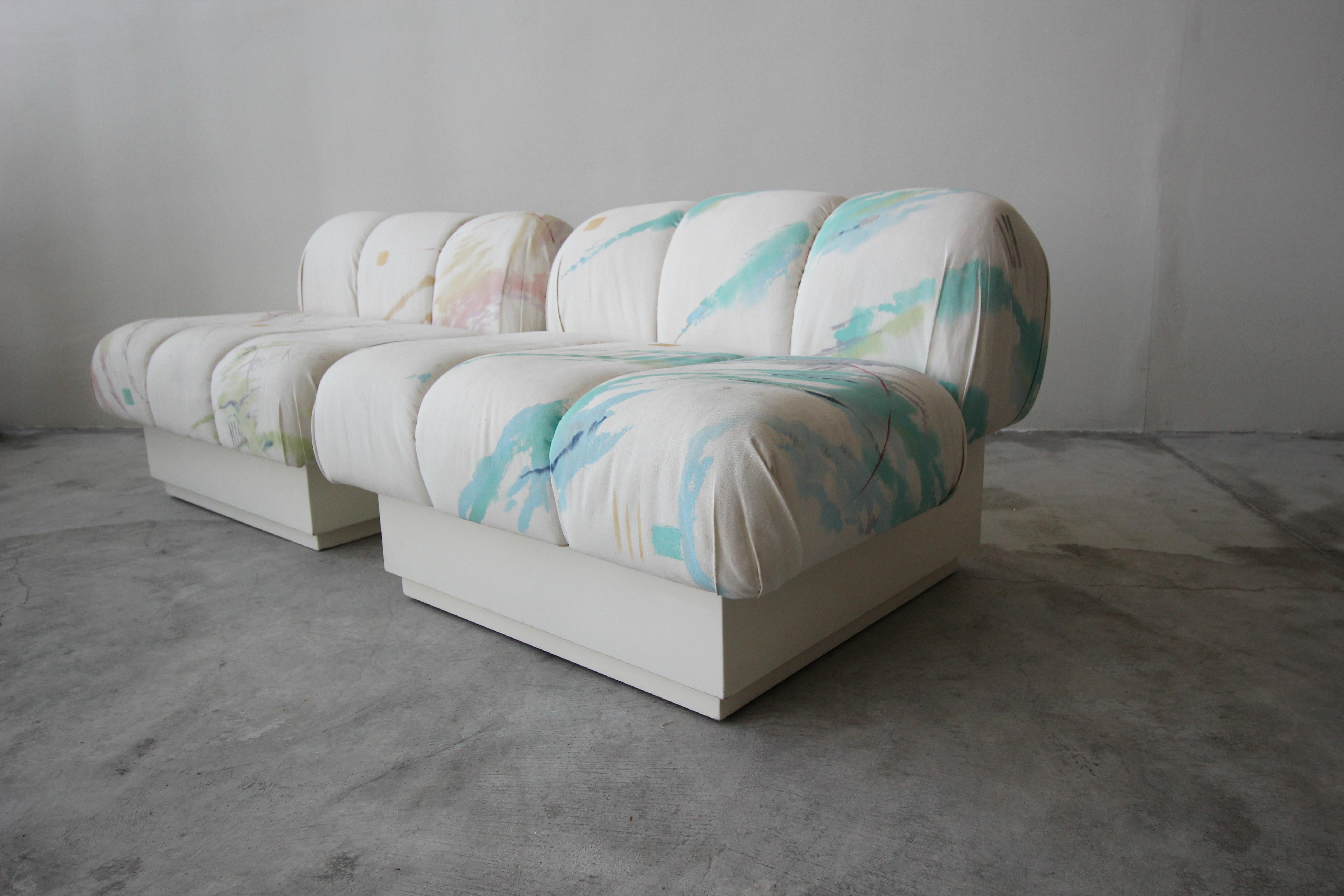 Incredible and large, Postmodern Italian style slipper chairs on a plinth bases. Most likely a custom pieces, these beauties truly have lines and curves worth coveting. 

Kept as found, in their pop art style, Touché, artist signed fabric. Chairs