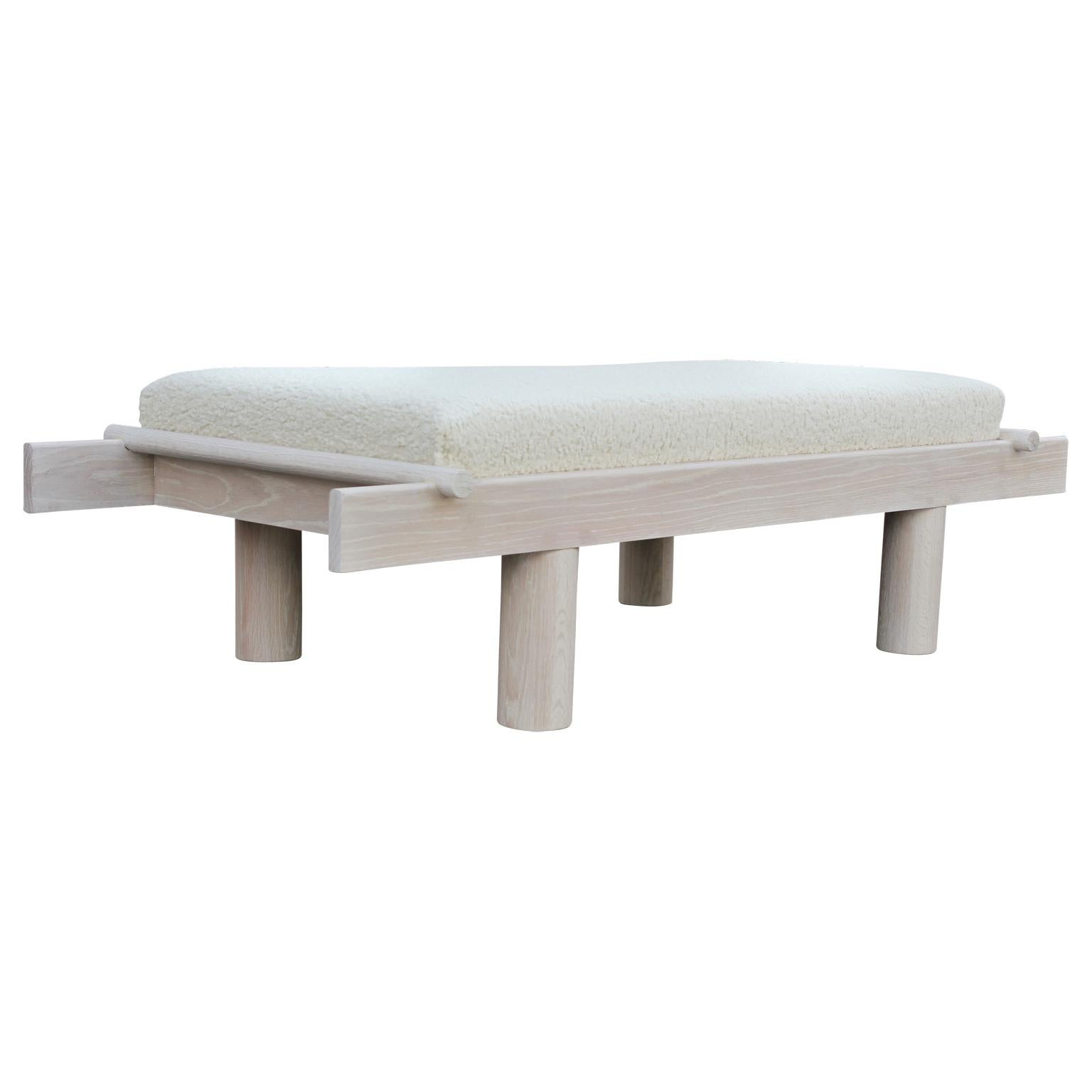 Custom modernist bench with a unique sculptural Postmodern design. The bench is made from natural cerused oak and the cushion is upholstered in a white shearling fabric. Made in Houston, TX by Reeves Design + Art local craftsman team.