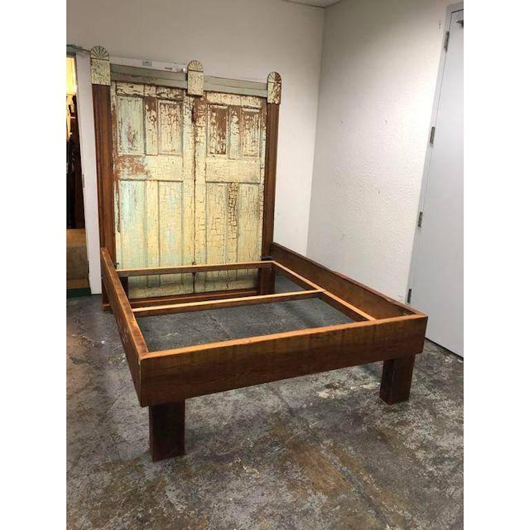 A custom bed frame. This custom Queen size bed was constructed from all reclaimed wood and doors as well as decorative Architectural elements. The bed has quite a presence! It does come in pieces, however the headboard stays intact as one piece. If