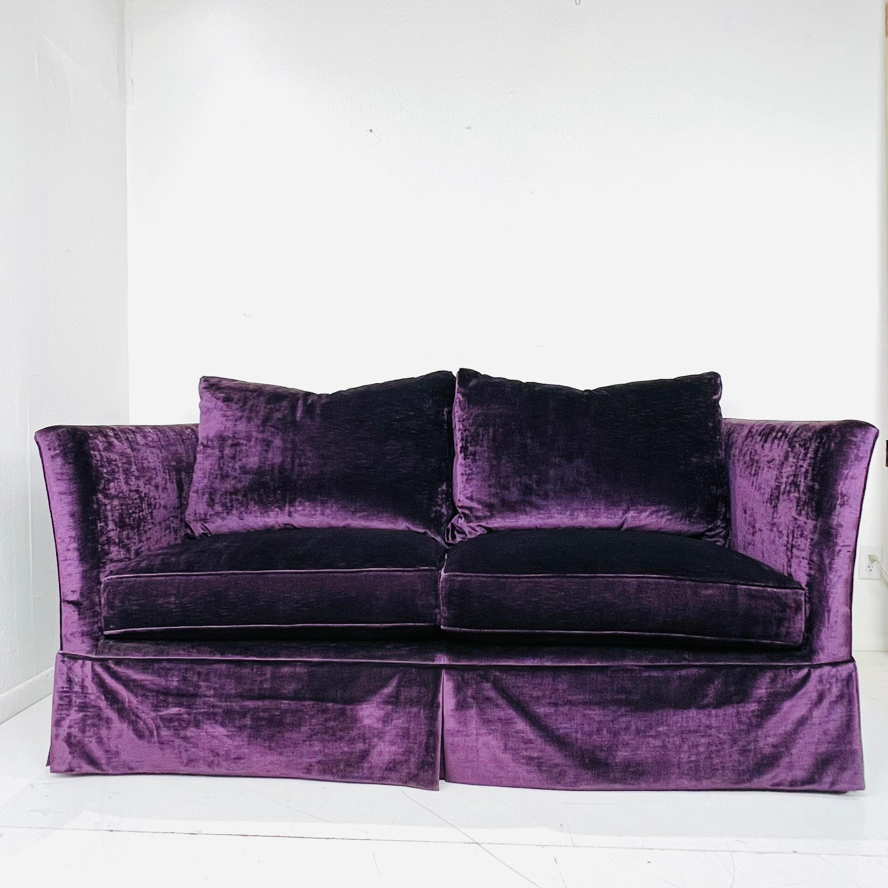 Breathtaking custom skirted sofa by Ralph Lauren, circa mid-90s. Bold royal purple chenille velvet upholstery in excellent condition. Cushions are down wrapped and seats are plush and incredibly comportable. Gorgeous and one-of-a-kind! 2 available!