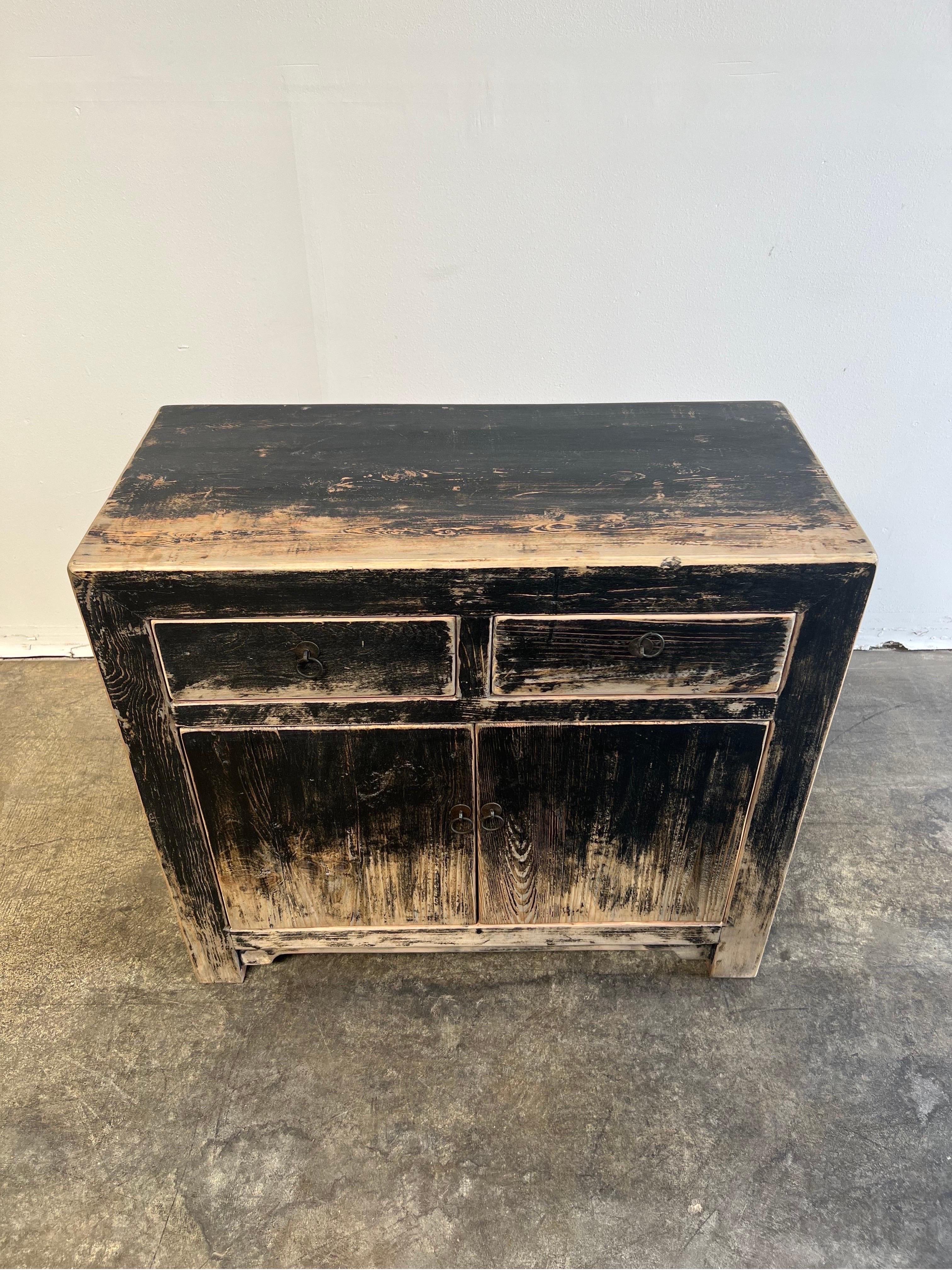 Vintage reclaimed elm wood 2 door with 2 drawers black distressed painted console. Perfect for an entry, use as a bar, in a dining room, or as a tv console. Doors open up with ease
Size: 33.5h x 38w x 17.75D.