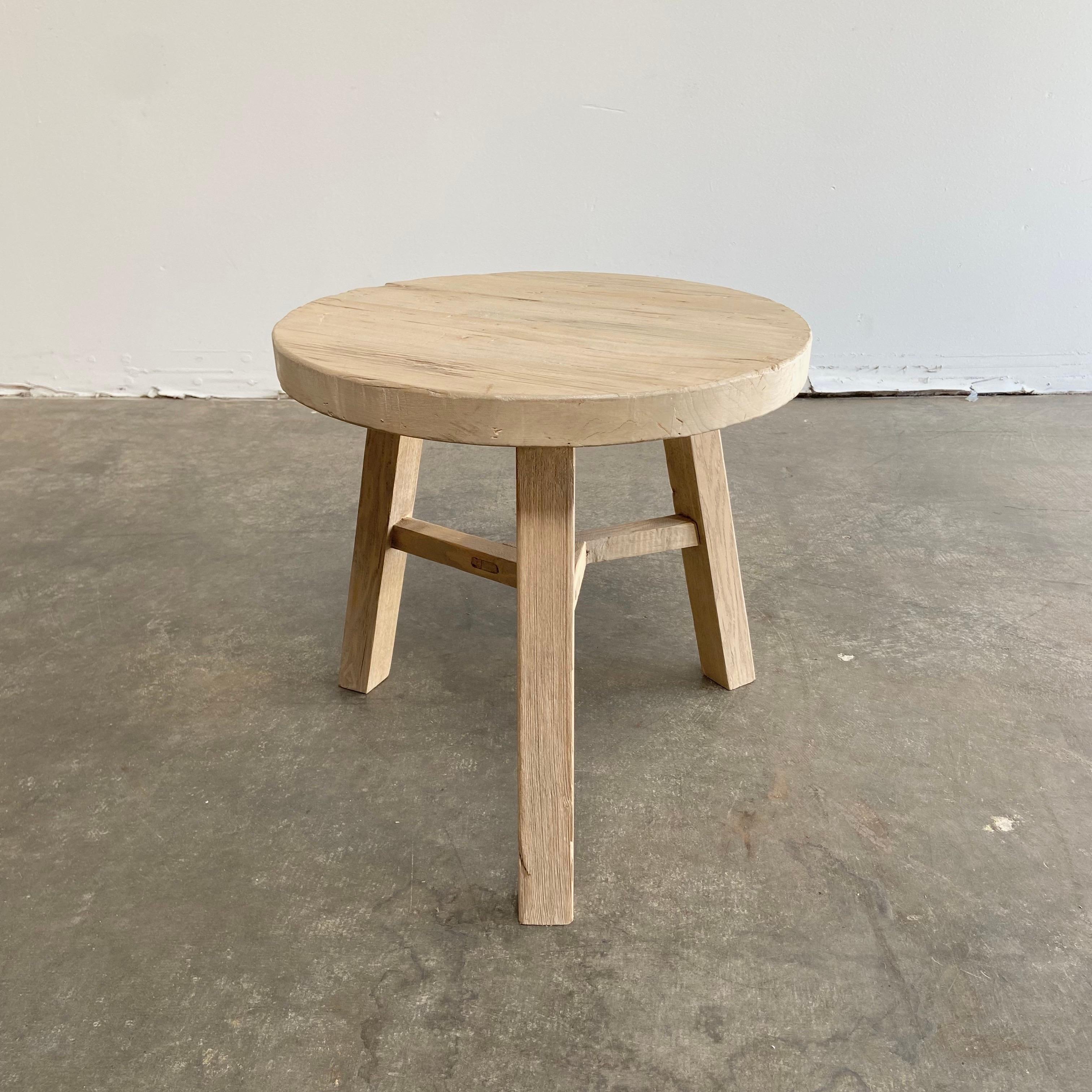 Round natural side table made from reclaimed elm wood raw natural finish, a warm honey with gray tones in the wood. Solid and sturdy, a great side table for next to a bed, sofa, chairs. Can be stained or painted for a customized look
 Size: 20” RD