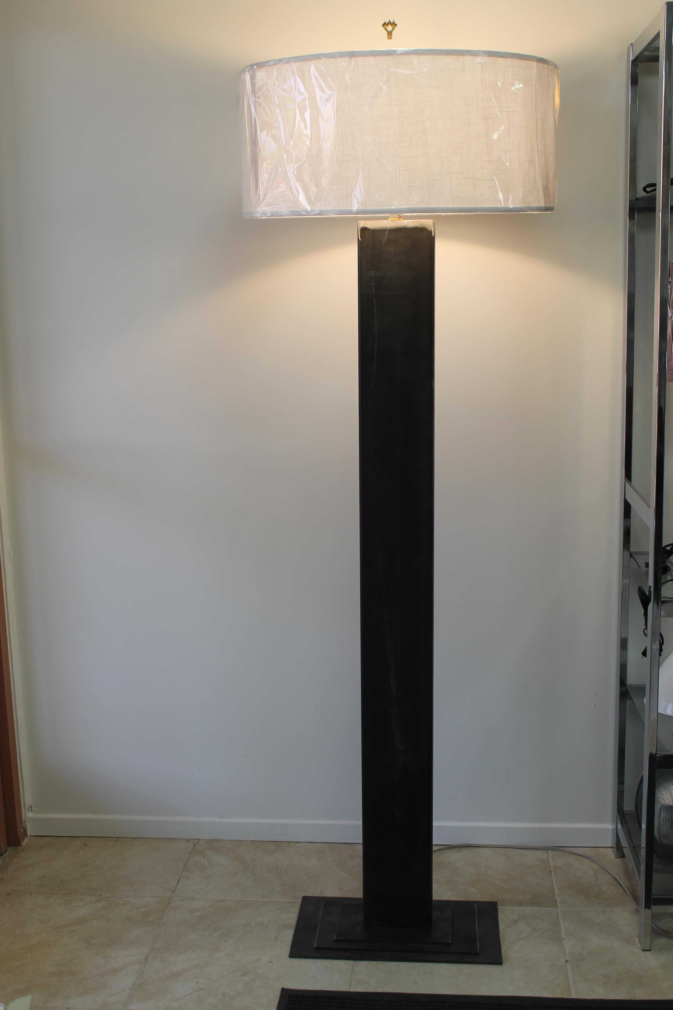 Contemporary studio designed rectangular steel floor lamp. We left the lamp in its raw unpolished state. Base is 3 layers and they measure 18” wide and 10” deep, 14” wide and 8” deep, 10” wide and 6” deep. Rectangular portion is 6” wide, 2” deep and