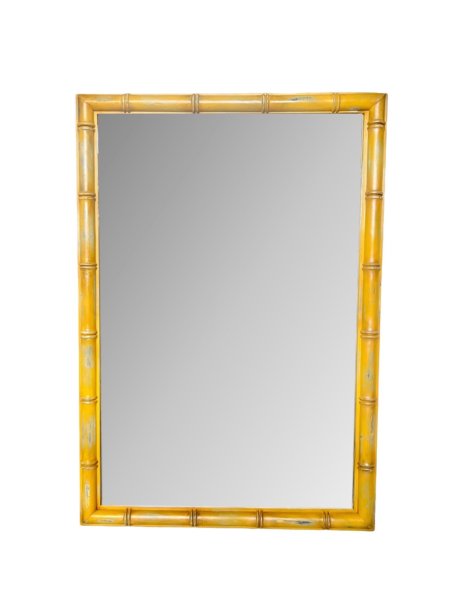 This vintage 1970's Dixie Furniture Palm Beach regency faux bamboo wall mirror has been custom refinished in a distressed satin mustard yellow with gray & cream undertones, dark wax details and pearlescent & gold highlights.

Dimensions: 27