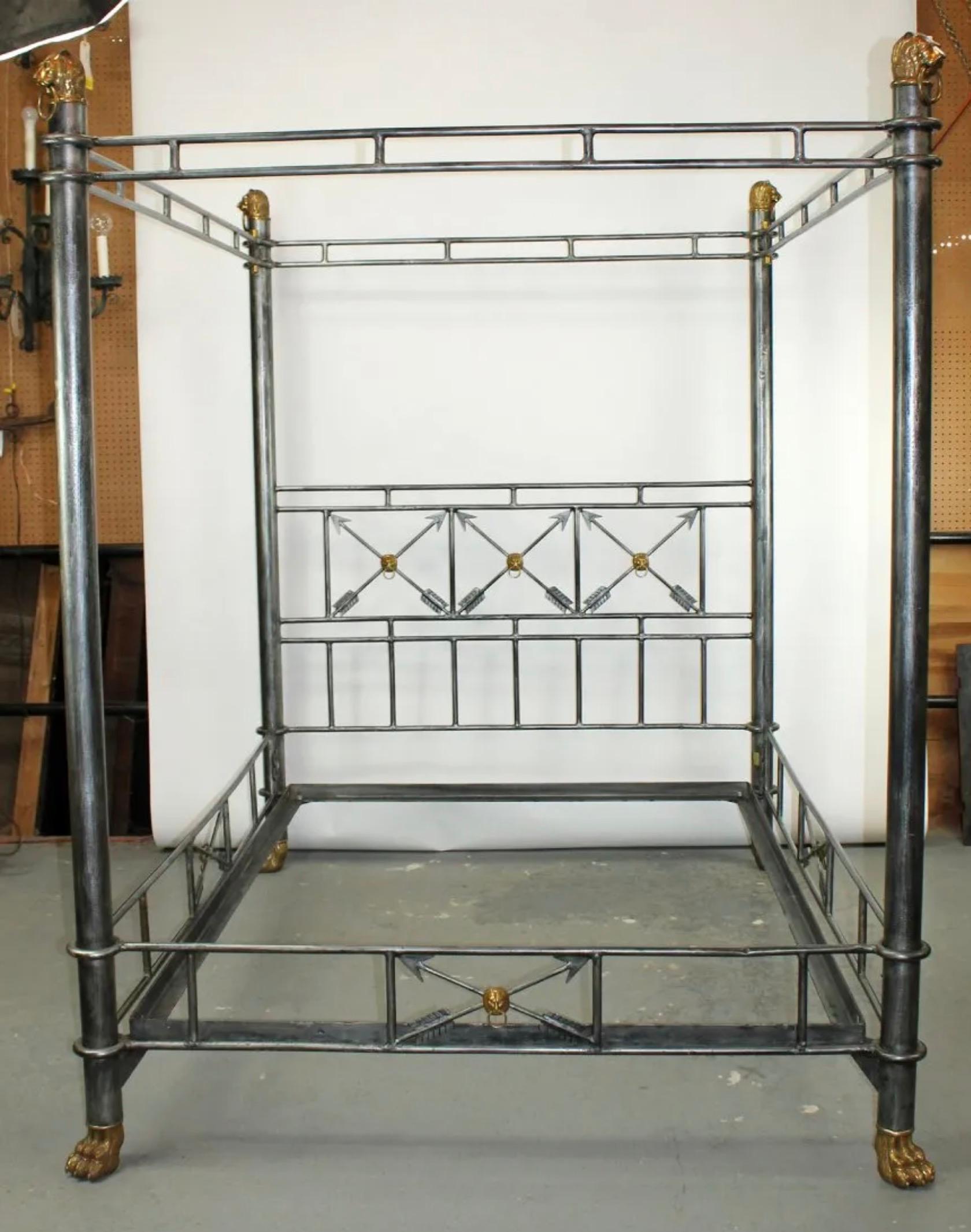 Hand forged iron queen sized canopy bed with brass lion heads, crossed arrows and paw feet. 