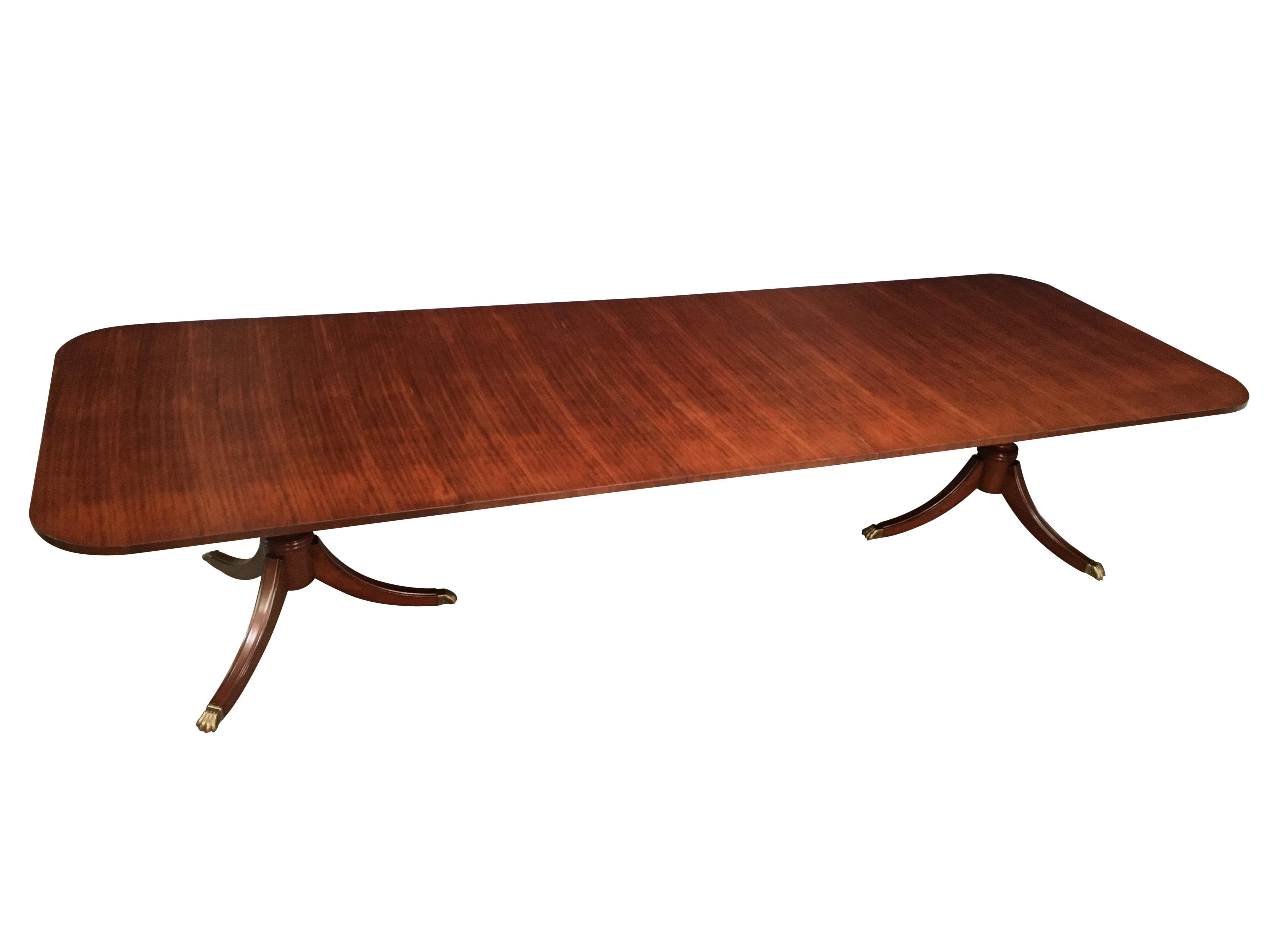 This is a made-to-order traditional ribbon mahogany dining table made in the Leighton Hall shop. It’s Classic look features a field of slip-matched ribbon cut mahogany. The finish is a handed rubbed and polished semigloss sheen. The Sheraton style