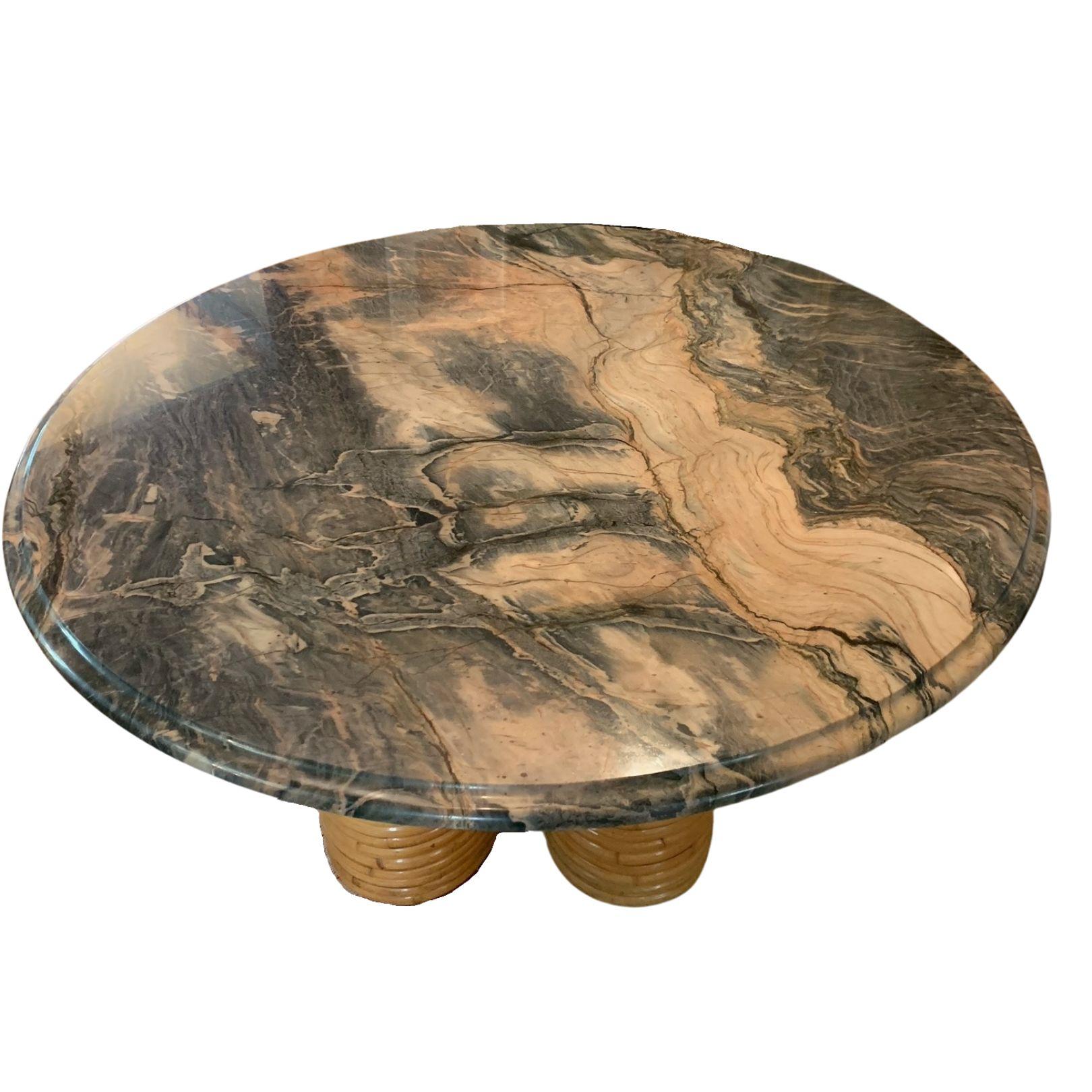 This maximalist, modern dining table would make a beautiful addition to any den or dining room. Crafted in the United States in 2020, this unique piece is composed of a heavy, round marble table top with dramatic grey, pink and brown veining. It